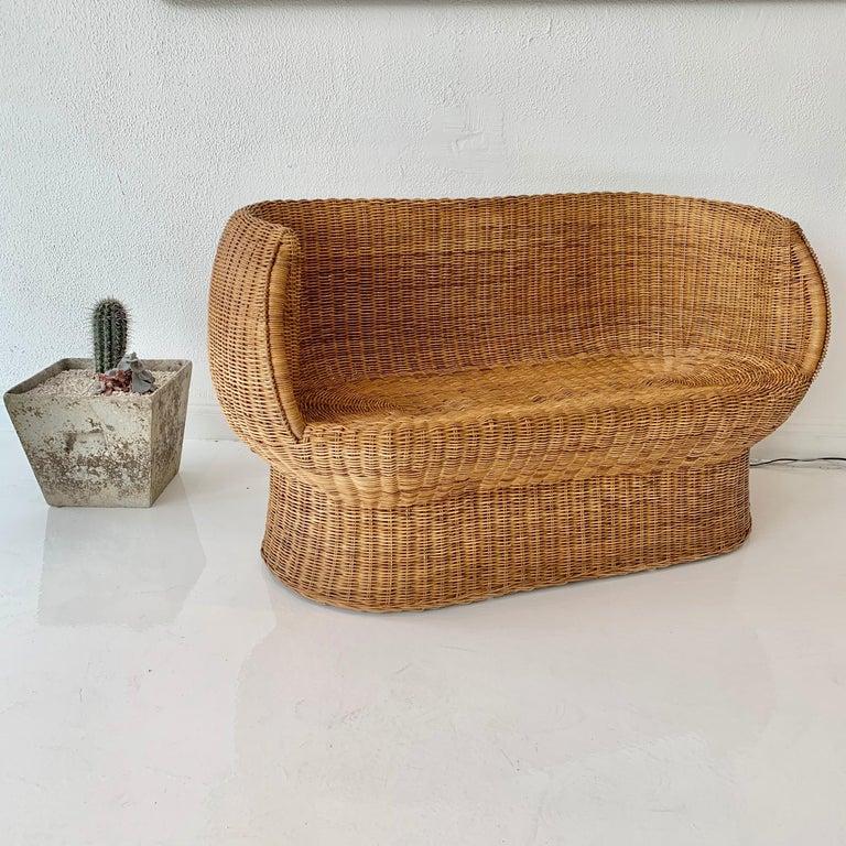 Gorgeous woven wicker settee by Isamu Kenmochi. Perfect scale, and very good condition. Rare, early piece of his work.
 