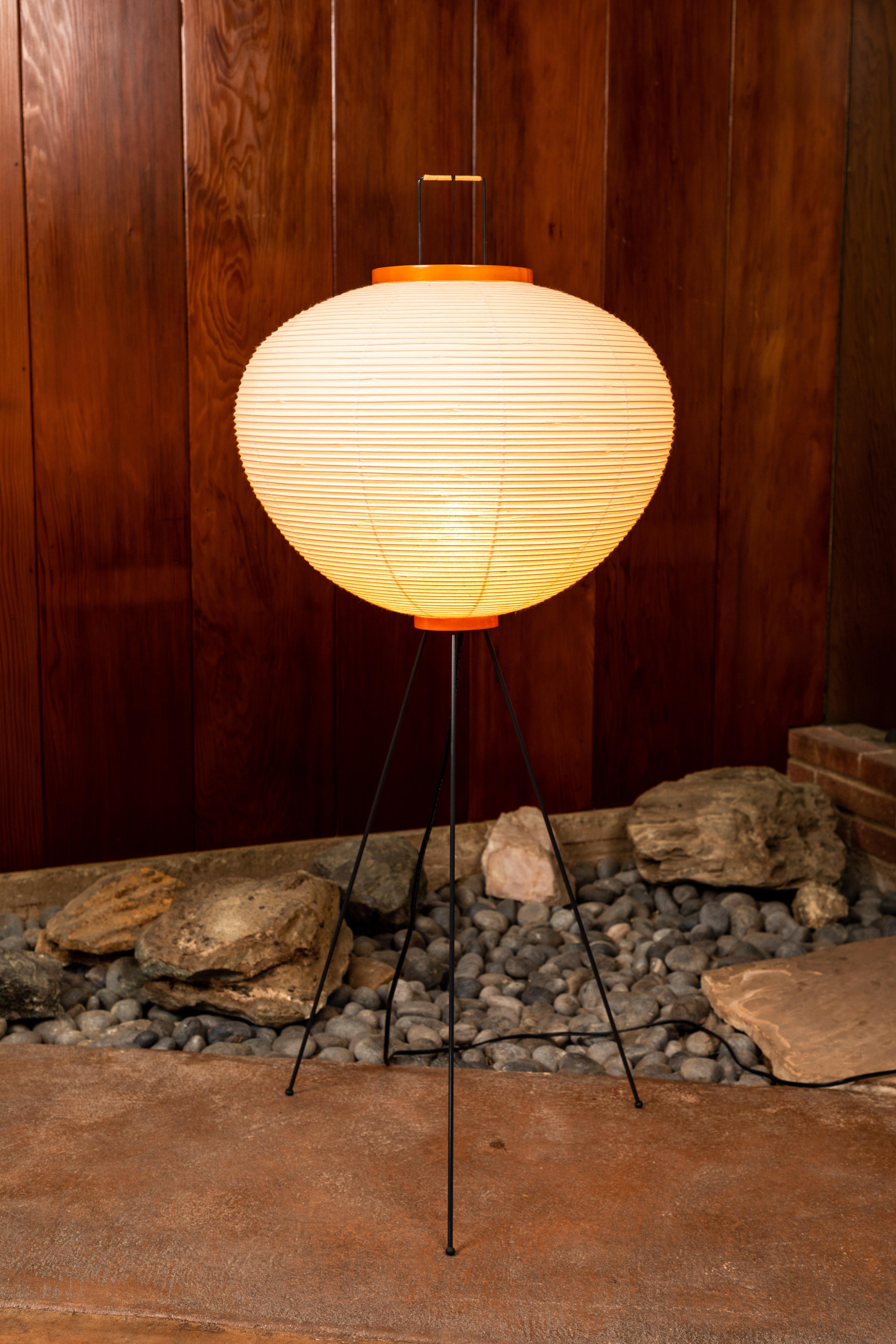 Isamu Noguchi Akari 10A floor lamp with signature. The shades are made from handmade washi paper and bamboo ribs with Noguchi Akari manufacturer's stamp. Akari light sculptures by Isamu Noguchi are considered icons of 1950s modern design. Designed