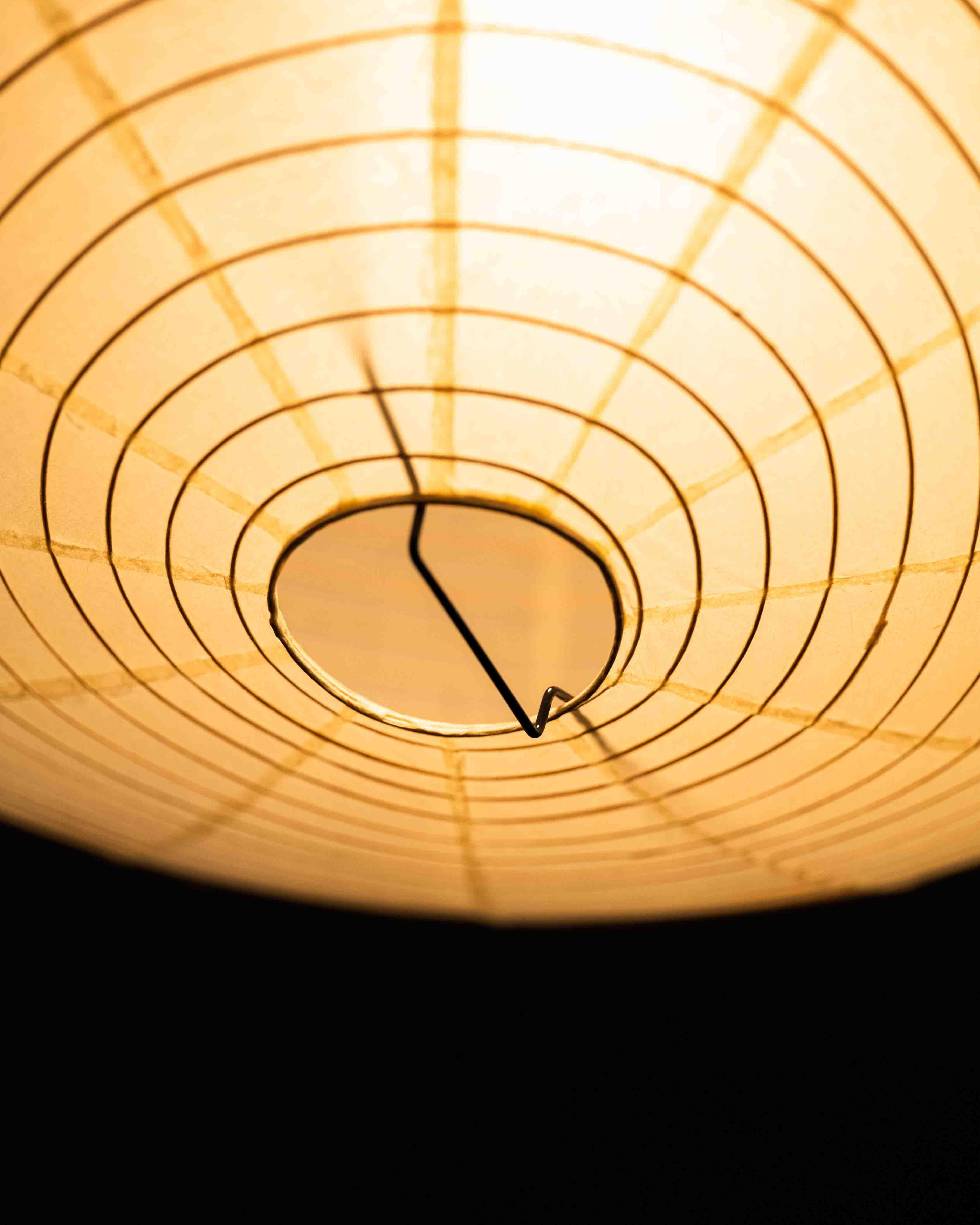Original Akari 16A light sculpture, designed by Isamu Noguchi. The iconic lamp features a creased ovoid paper shade supported by a minimalist metal frame, exemplifying Noguchi’s blend of Japanese craft and modernist form.