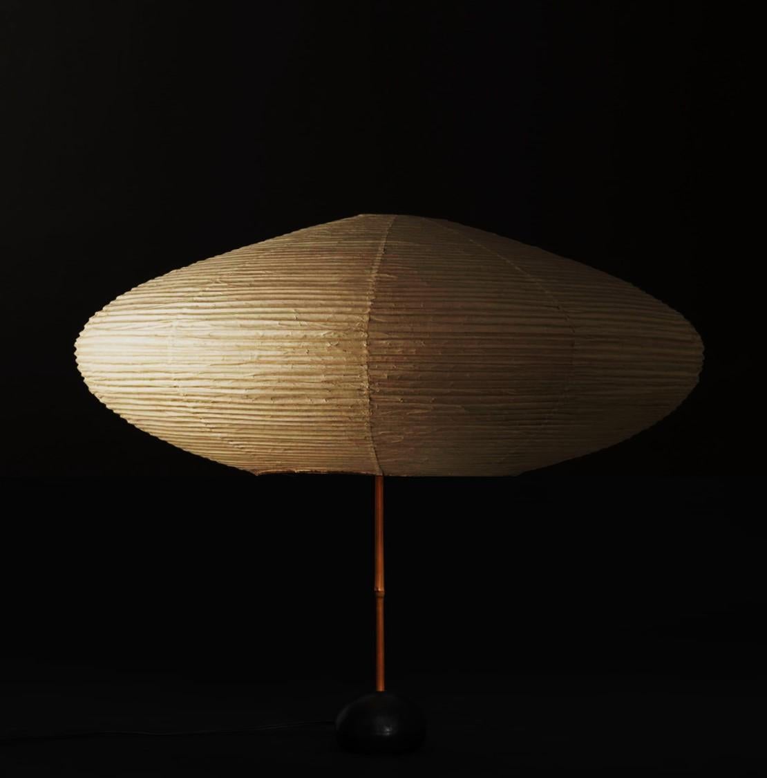 ISAMU NOGUCHI
Akari model “21A” on BB2 Base 
Original shade in washi, bamboo rings & bamboo rims
Structure in black lacquered metal
Hand-made form realized by Ozeki Company, Gifu, Japan
Series started in 1951
Height: 26 in. / Diameter: 25 1/2 in.