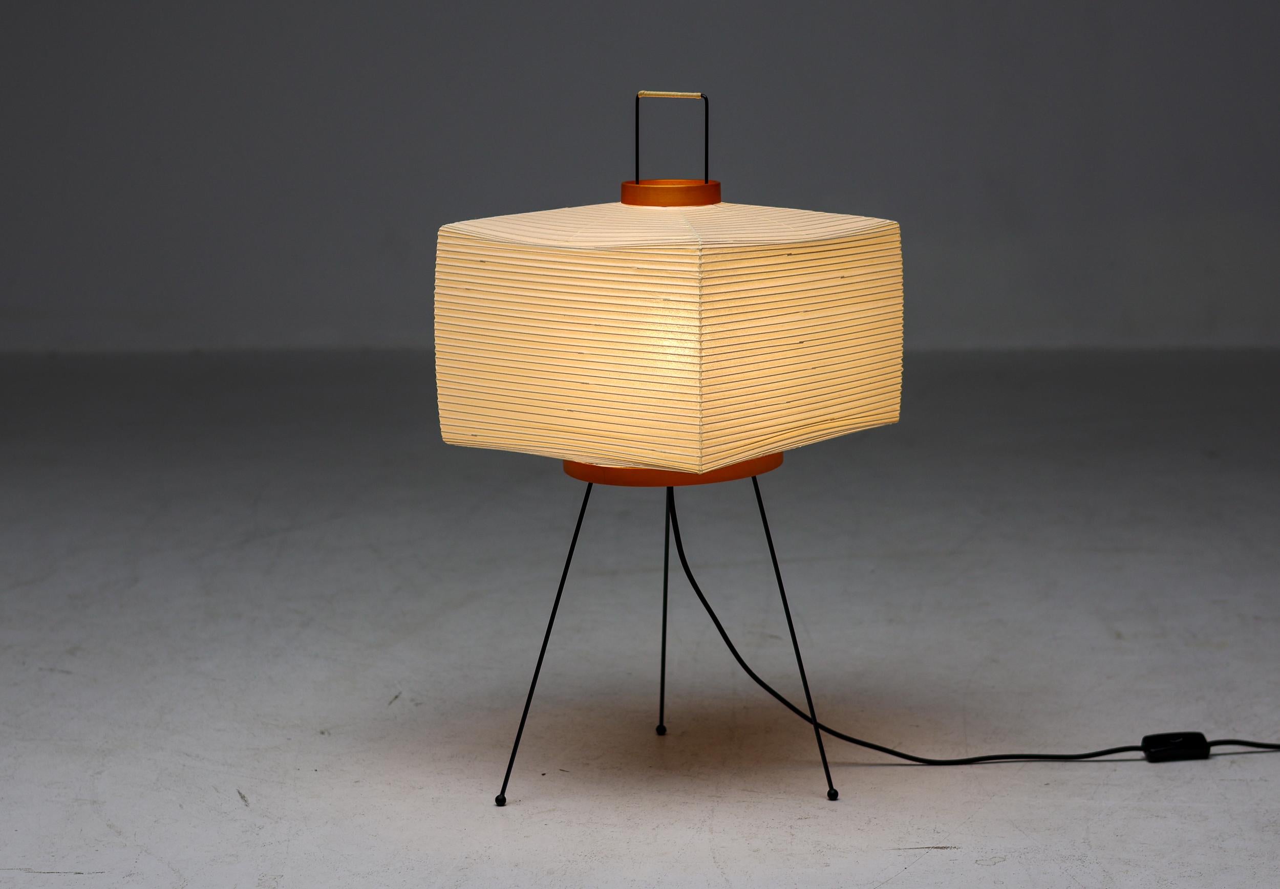 Model number 7A table or floor lamp by Isamu Noguchi for Akari. 
Original version manufactured by Ozeki & co in Japan. 
Rice paper, enameled metal. Retains manufacturer's original stamp, original box included.
Excellent all original condition.