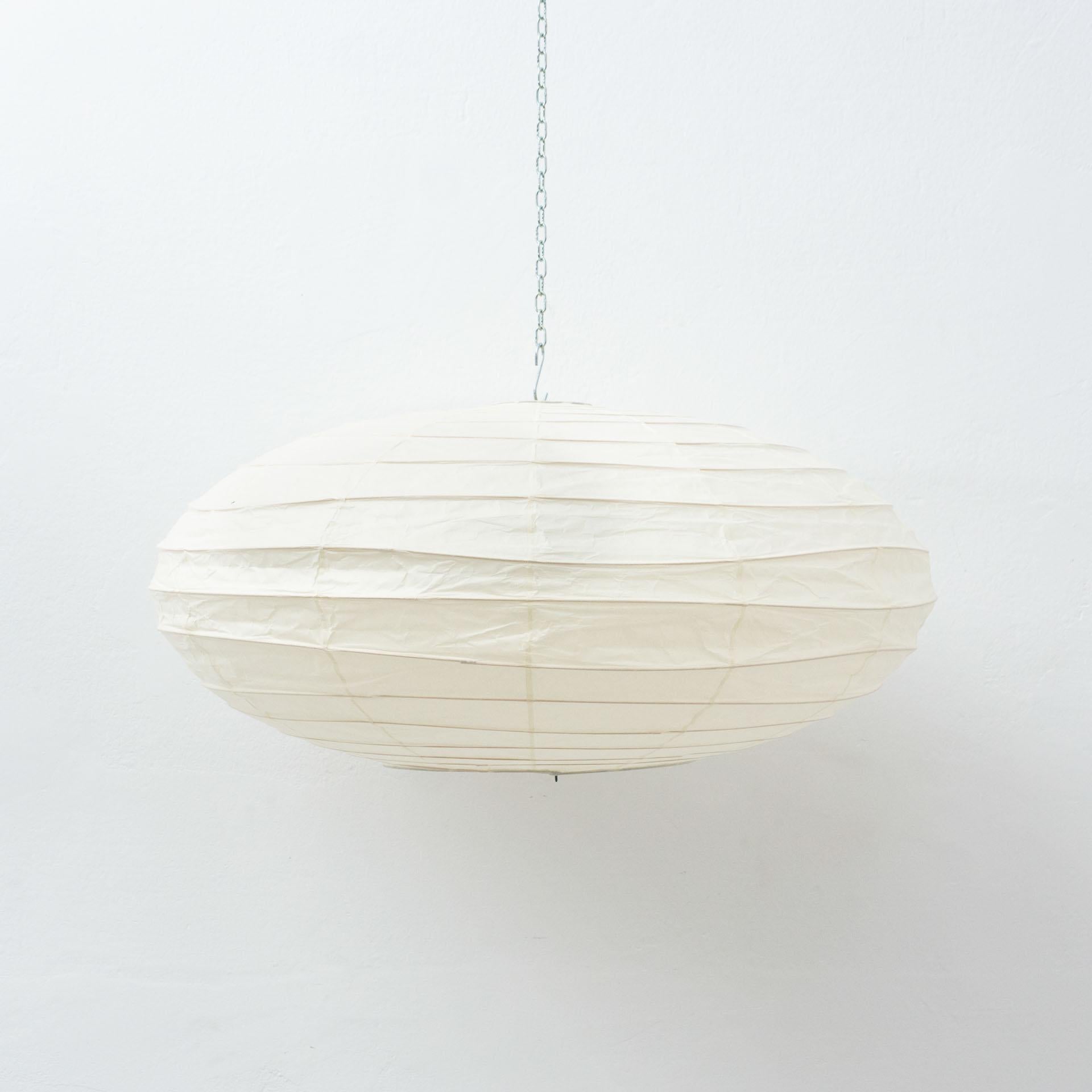 Pendant lamp model 70EN designed by Isamu Noguchi.
Manufactured by Ozeki & Company Ltd. (Japan.)
Bamboo ribbing structure covered by washi paper manufactured according to the traditional procedures.

In original condition, with minor wear
