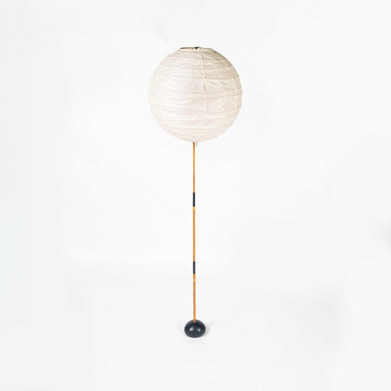 An iconic vintage Isamu Noguchi Akari floor lamp, model BB3-55DD, ca. 1970s. Bamboo and enameled steel with a paper shade. The paper shade is in excellent condition for its age, with minimal wear and tears (two small holes by the edge of the ring).