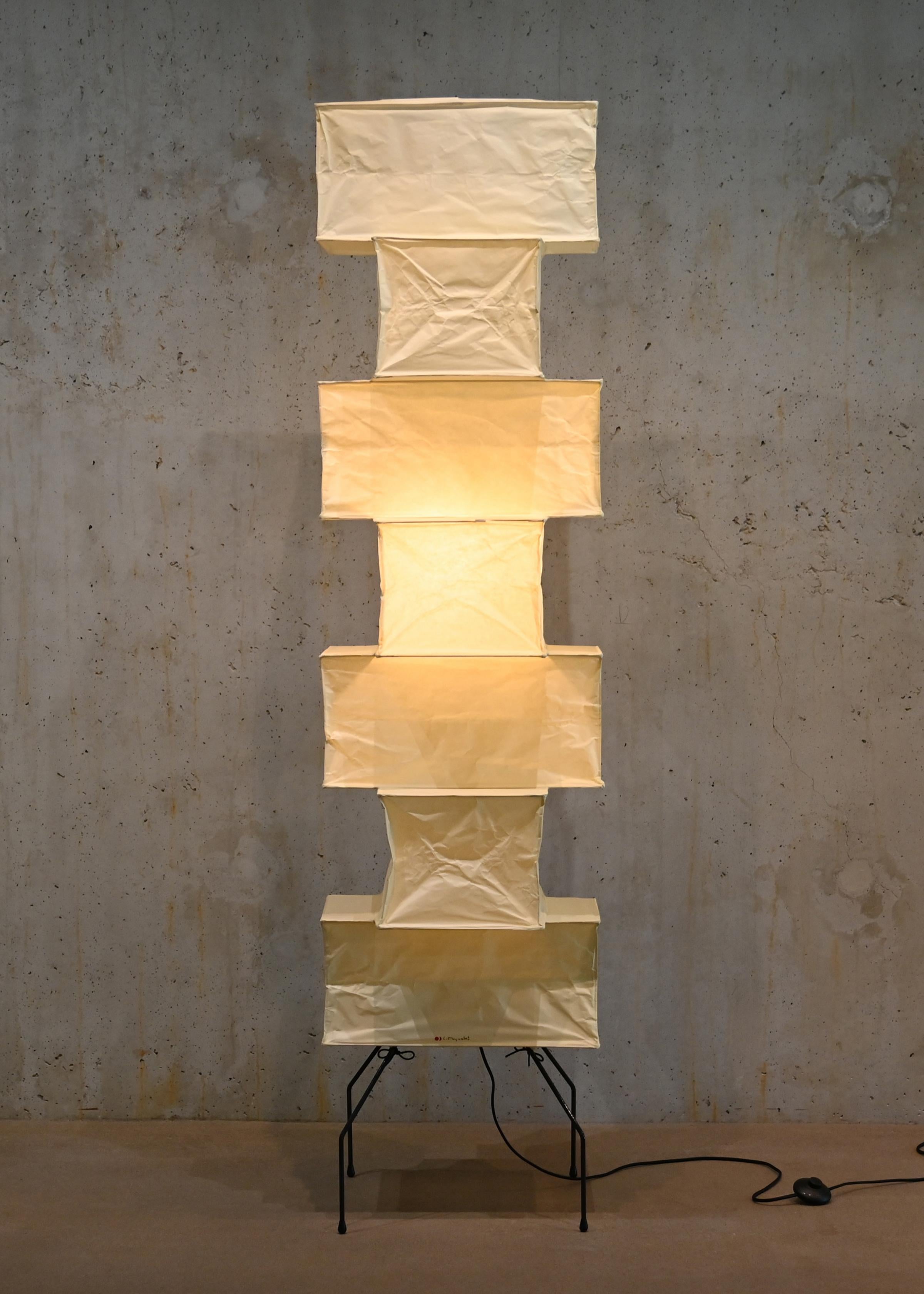 Iconic Akari light sculpture / large floor lamp known as Model UF4-L10 designed by Isamu Noguchi and handcrafted from traditional washi paper and bamboo. Each Akari lamp shade is meticulously crafted by hand in the Ozeki workshop, a traditional
