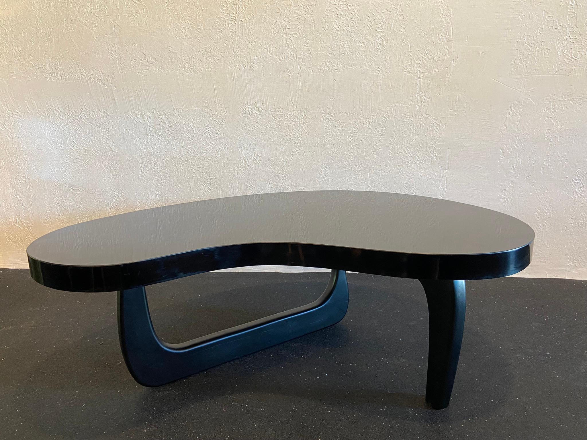 Isamu Noguchi style biomorphic coffee table. Extremely rare form, utilizing a molded mica wrapped solid wood top. Surface scratches to the top (please refer to photos).

Would work well in a variety of interiors such as modern, mid century modern,