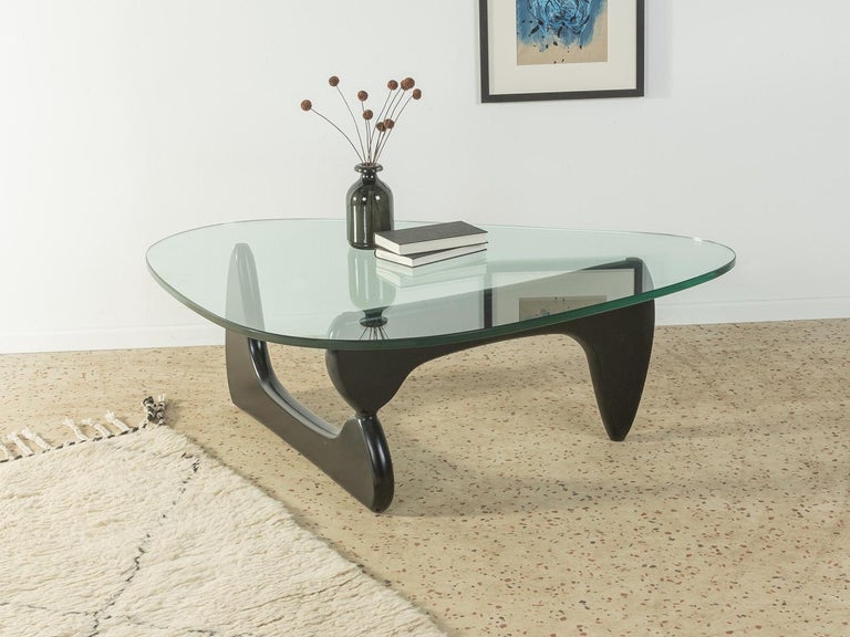 Sculptural coffee table by Isamu Noguchi for Vitra / Herman Miller, designed in the 1940s. High-quality solid wood frame made of black lacquered ash wood with 19mm thick table top made of glass.

Quality features:
 Accomplished design: perfect