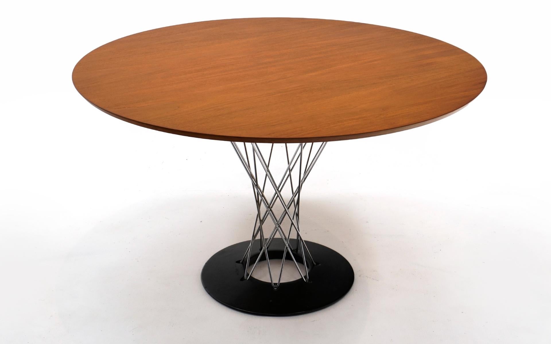 Early and rare Noguchi Cyclone table. Out of production 48 inch round Teak top which has been expertly refinished. The chrome is free of pitting. The heavy iron base shows scuffs and light scratches from use. This is a fine example of this out of