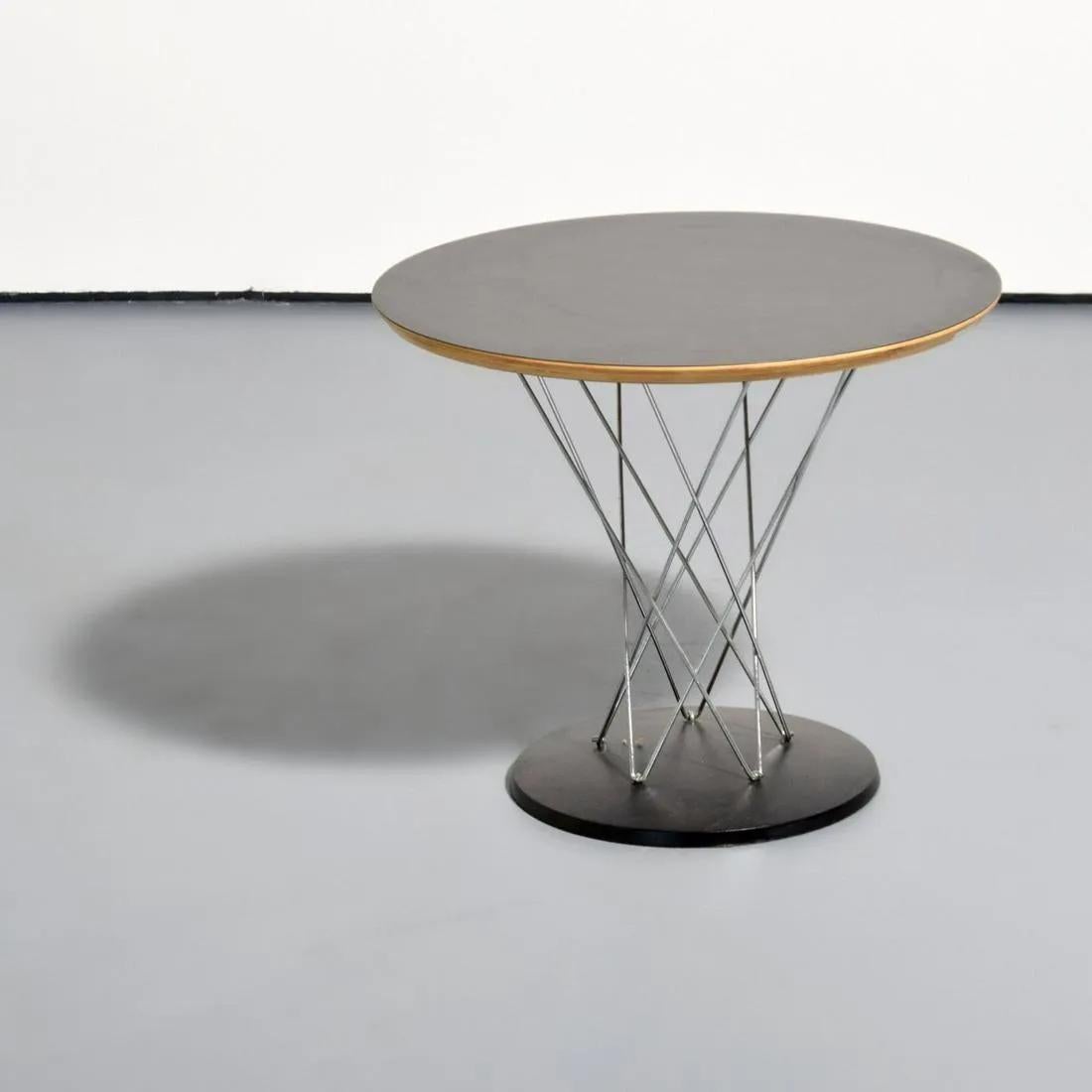 A timeless and iconic design piece, the Cyclone end or side table also referred to as Child table designed by Isamu Noguchi (American, 1904-1988) for Knoll. 
The rare Mid-Century Modern take features a black laminated top connected with chrome to a