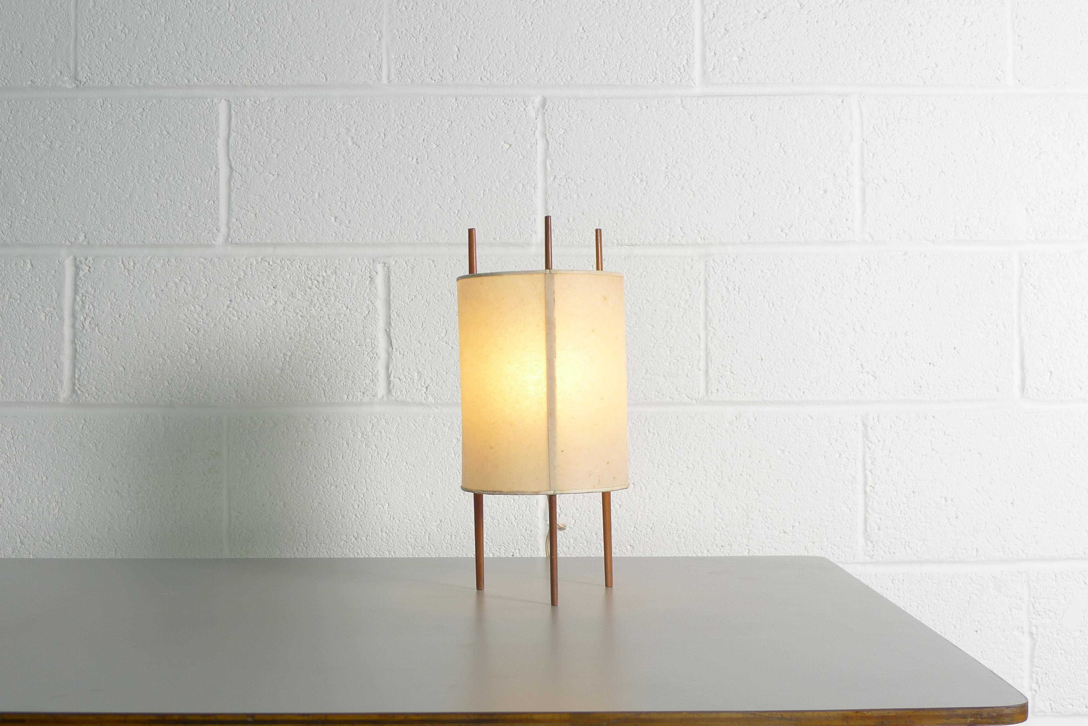 Isamu Noguchi tripod table lamp, model 9, designed circa 1947 for Knoll International.

Original cylinder fiberglass shade and wooden supports appear untouched.