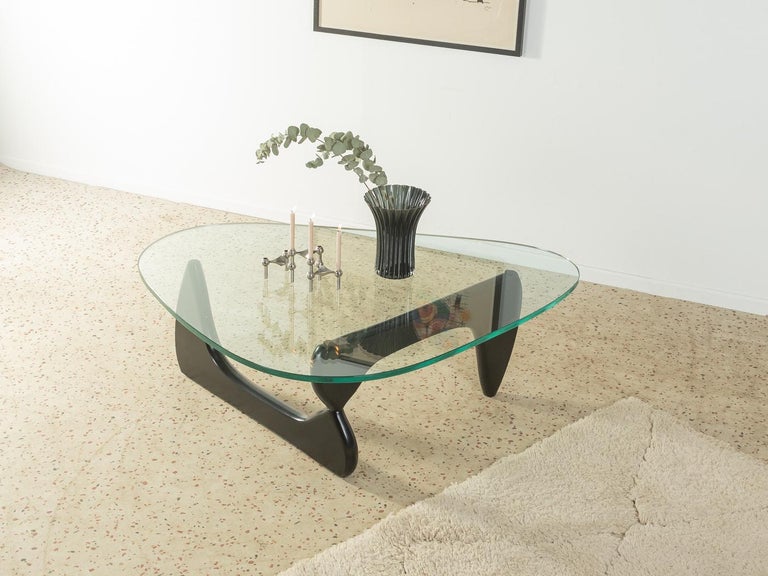 Sculptural coffee table by Isamu Noguchi for Vitra / Herman Miller, designed in the 1940s. High-quality solid wood frame made of black lacquered ash wood with 19mm thick table top made of glass.

Quality Features:
 accomplished design: perfect