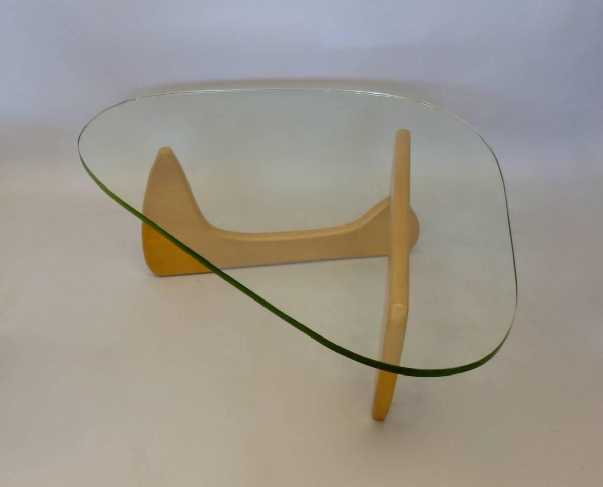 Original early and rare iconic Isamu Noguchi blond base cocktail table. Model IN-50 introduced in 1950. This is one of three tables I purchased from an artists estate about two years ago. Very nice original early green edge glass top .There is one