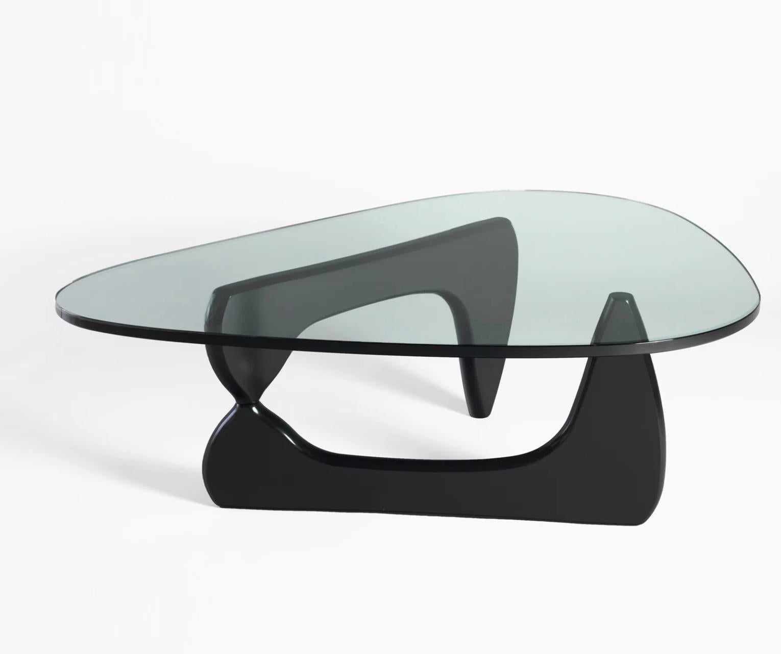This classic table authorized by the Isamu Noguchi Foundation was originally created in 1944. The brilliantly simple design consists of only three elements, the glass top and two interlocking wood base pieces. The table is an extraordinary harmony