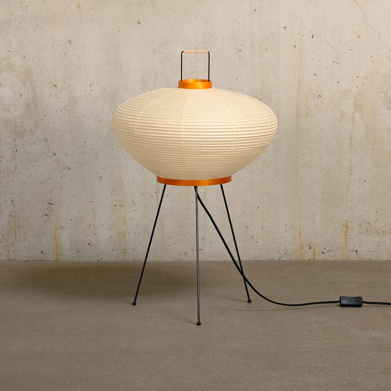 Iconic Akari light sculpture known as Model 9A designed by Isamu Noguchi and handcrafted from traditional washi paper and bamboo. Each Akari lamp shade is meticulously crafted by hand in the Ozeki workshop, a traditional family-owned company, based