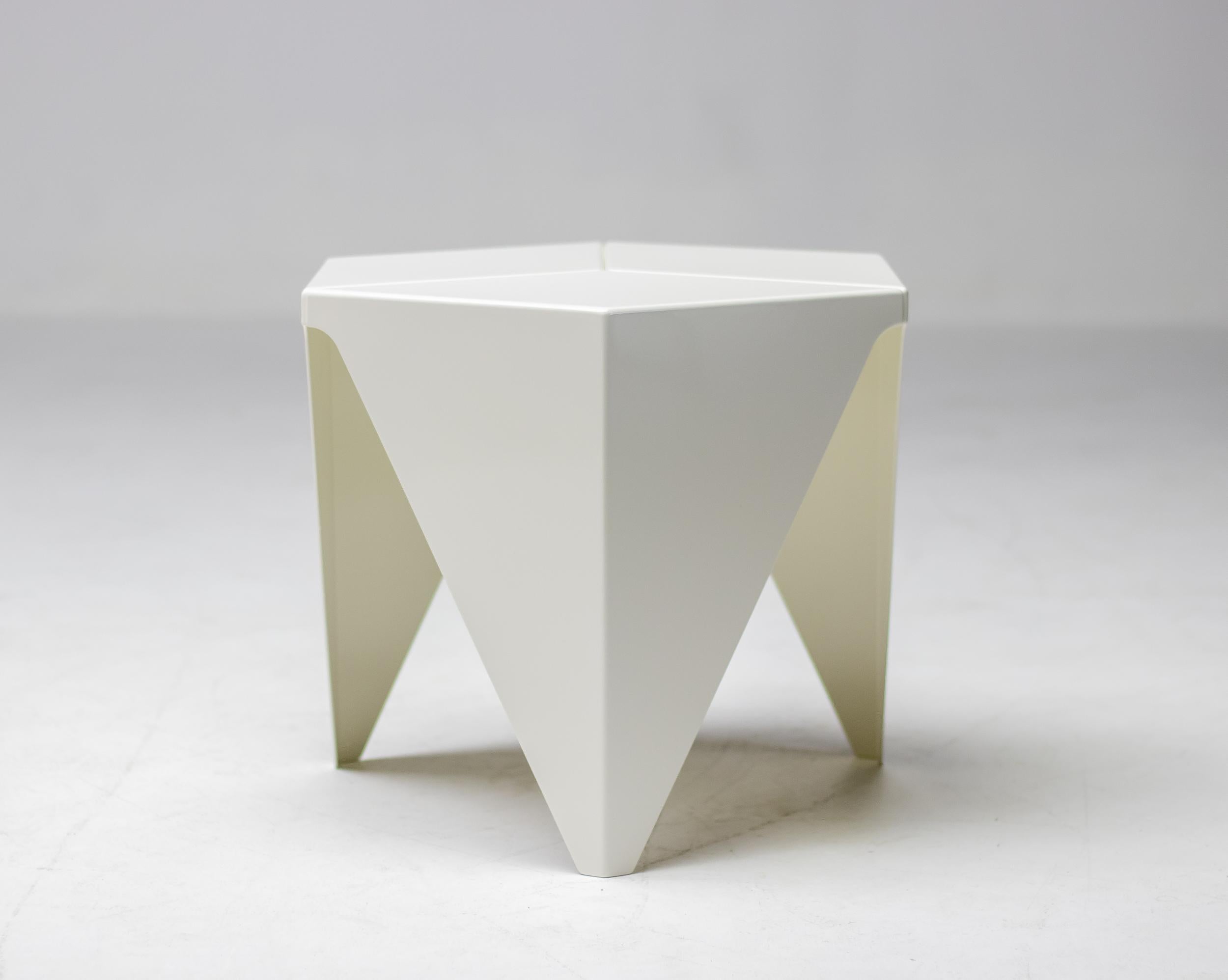 A Prismatic table in white enameled aluminum by Isamu Noguchi for Vitra. The table design was based on geometric forms and has an interesting three-legged base with a hexagonal top. Made of folded sheet aluminium inspired by Japanese paper folding