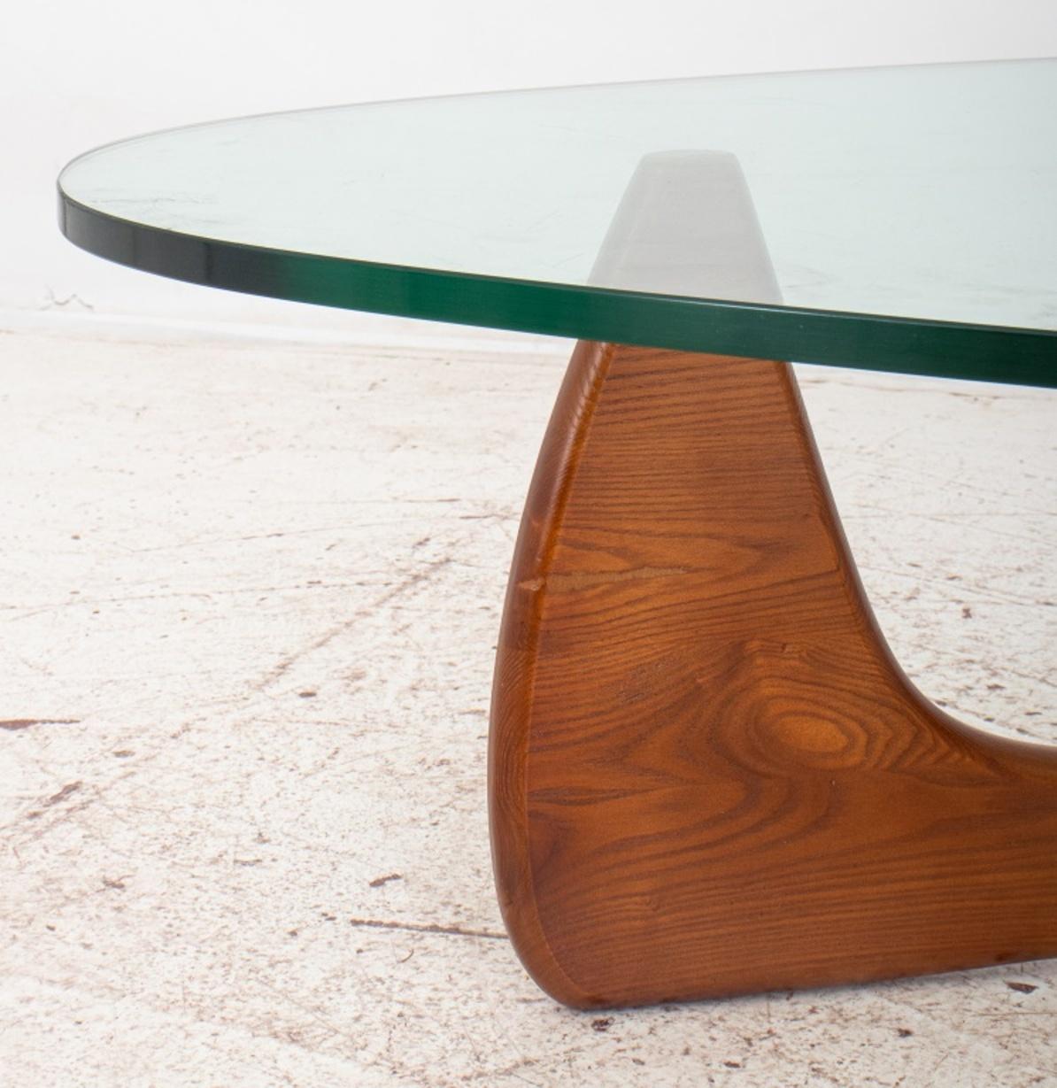 After Isamu Noguchi (American, 1904-1988) 1947 design for Herman Miller in walnut and smoked glass.

Dimensions: 15.75