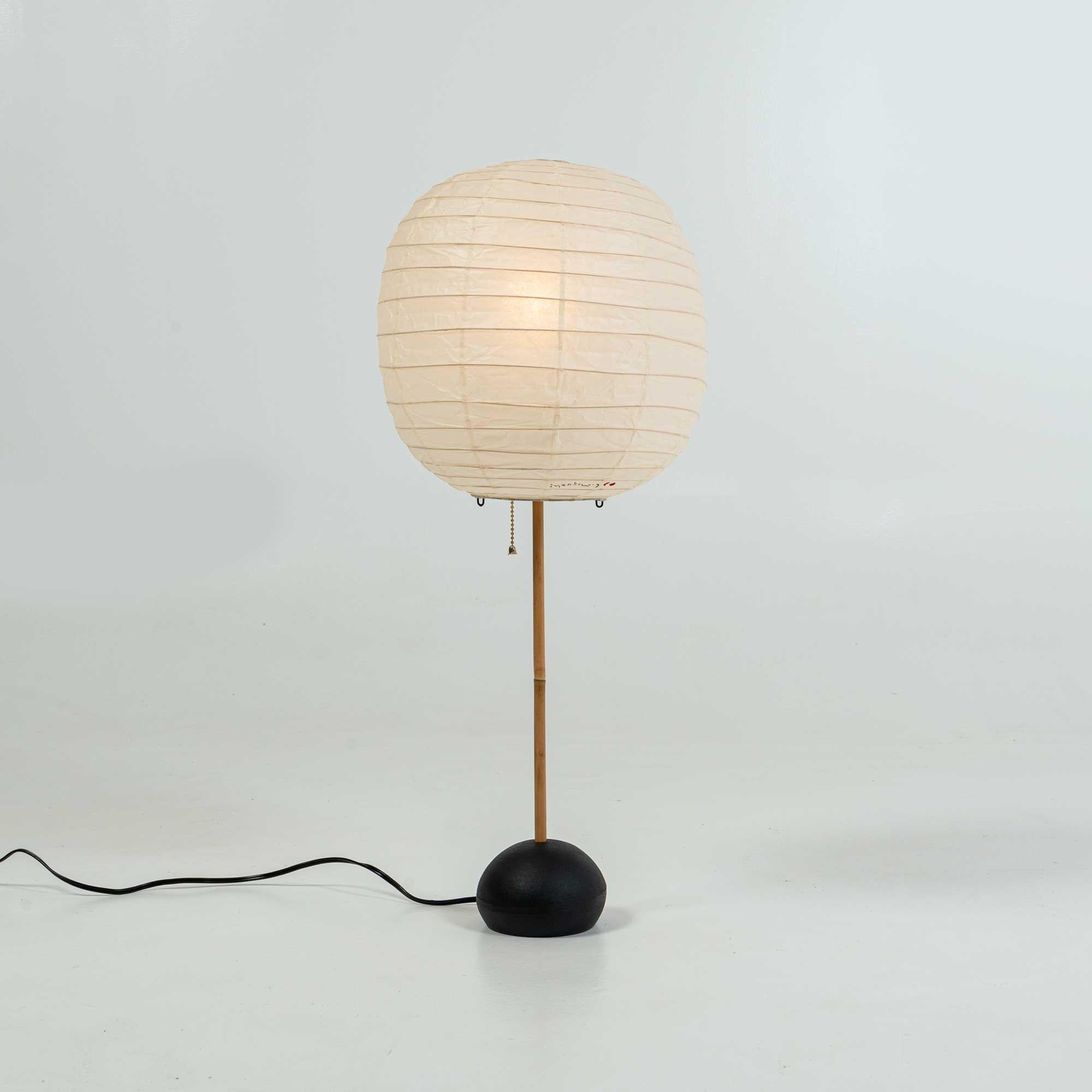 A 1980s production of the Isamu Noguchi Table Lamp, BB1 base with 30F shade. Overall in great condition, some light discoloration on the shade, some patina on the metal base. wired 110v. Ready for use.