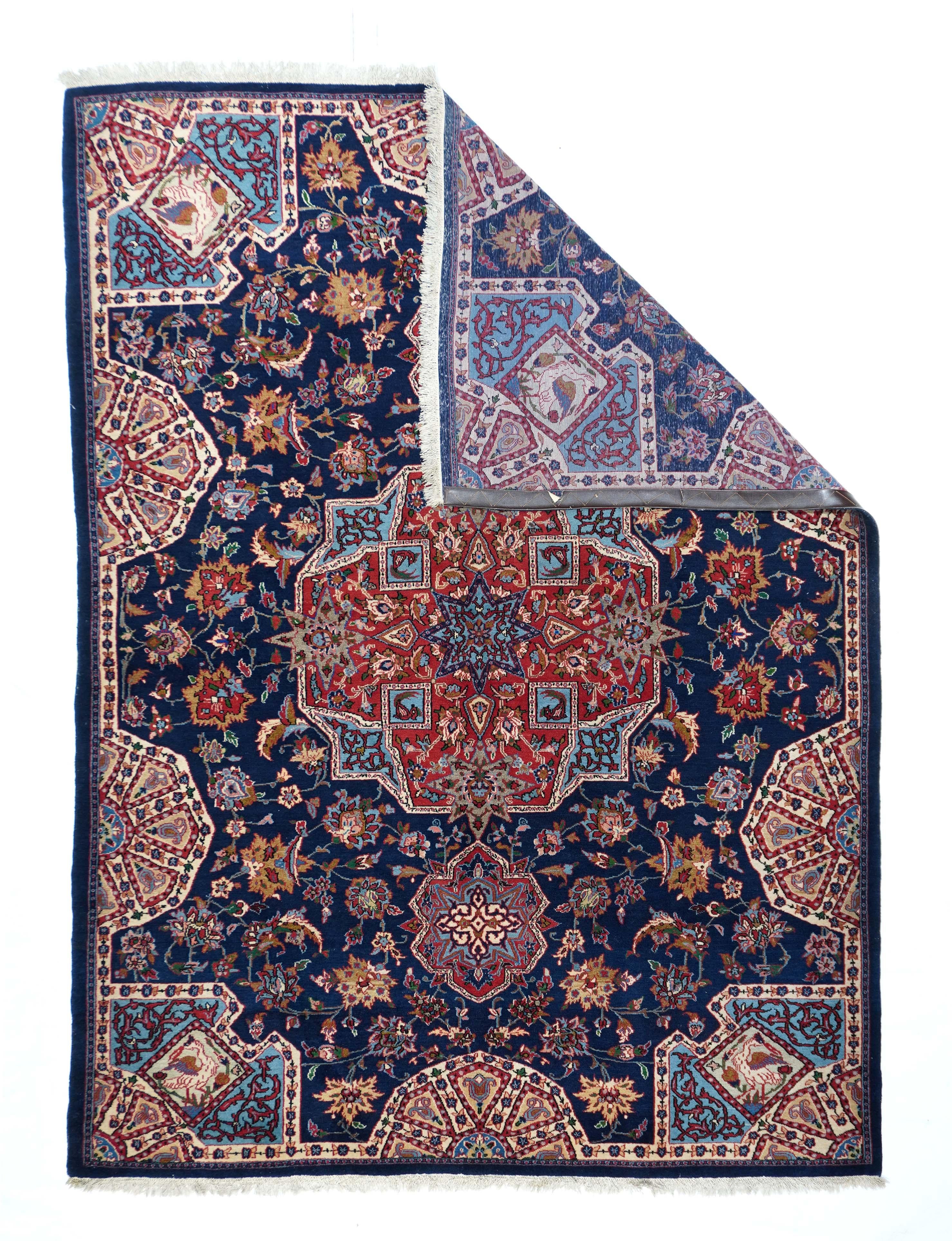 Whereas the vast majority of finely woven, central Persian Isfahan city rugs are in lighter palettes with distinct field, medallion and borders, this scatter shows a jewel-tone palette with a navy field, red cruciform over octogramme medallion,