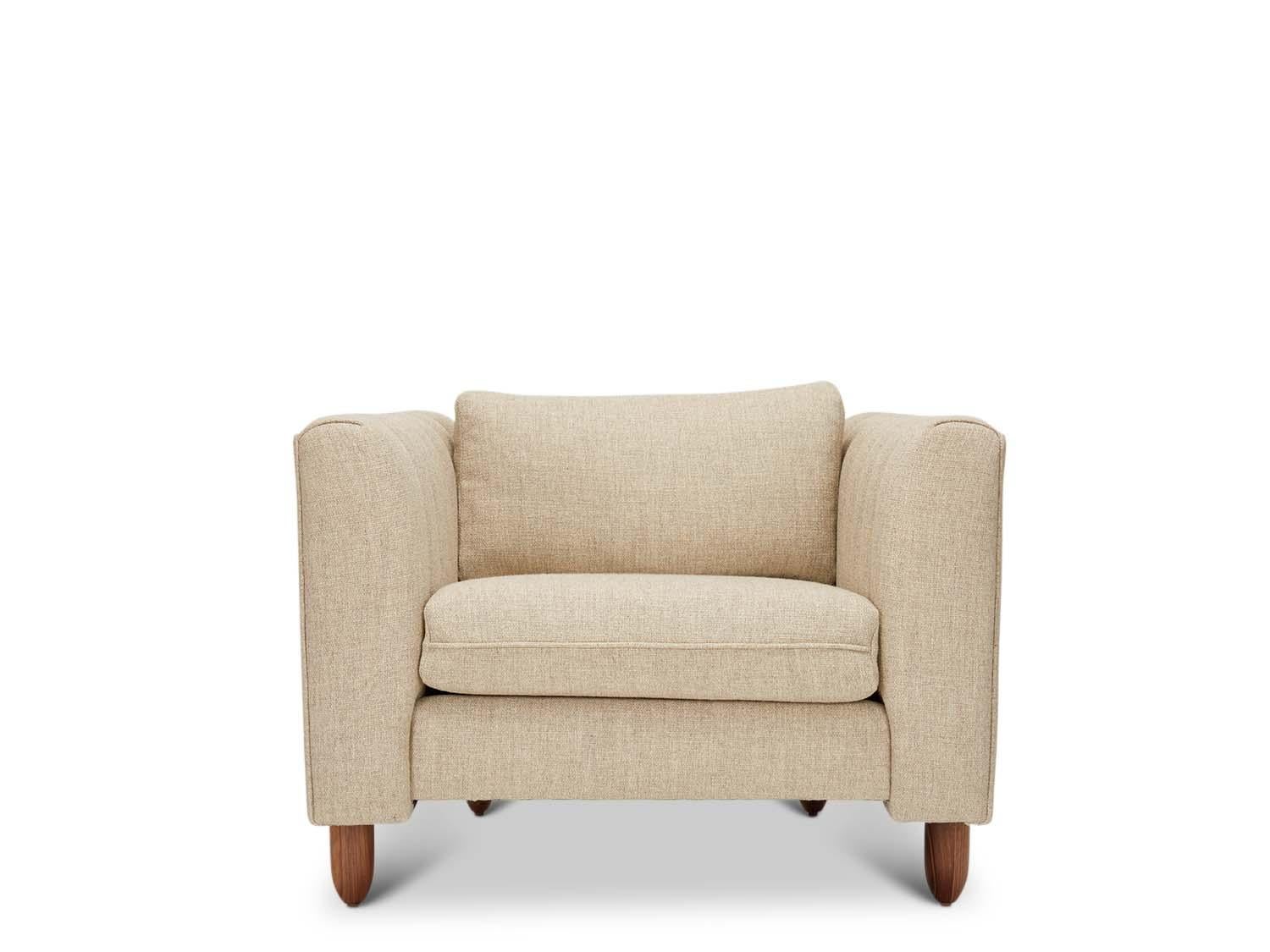 The Isherwood chair features a channel tufted body with loose seat and back cushions. The turned legs are made of solid white oak or American walnut and are inset on the sides revealing the leg detail.

The Lawson-Fenning Collection is designed