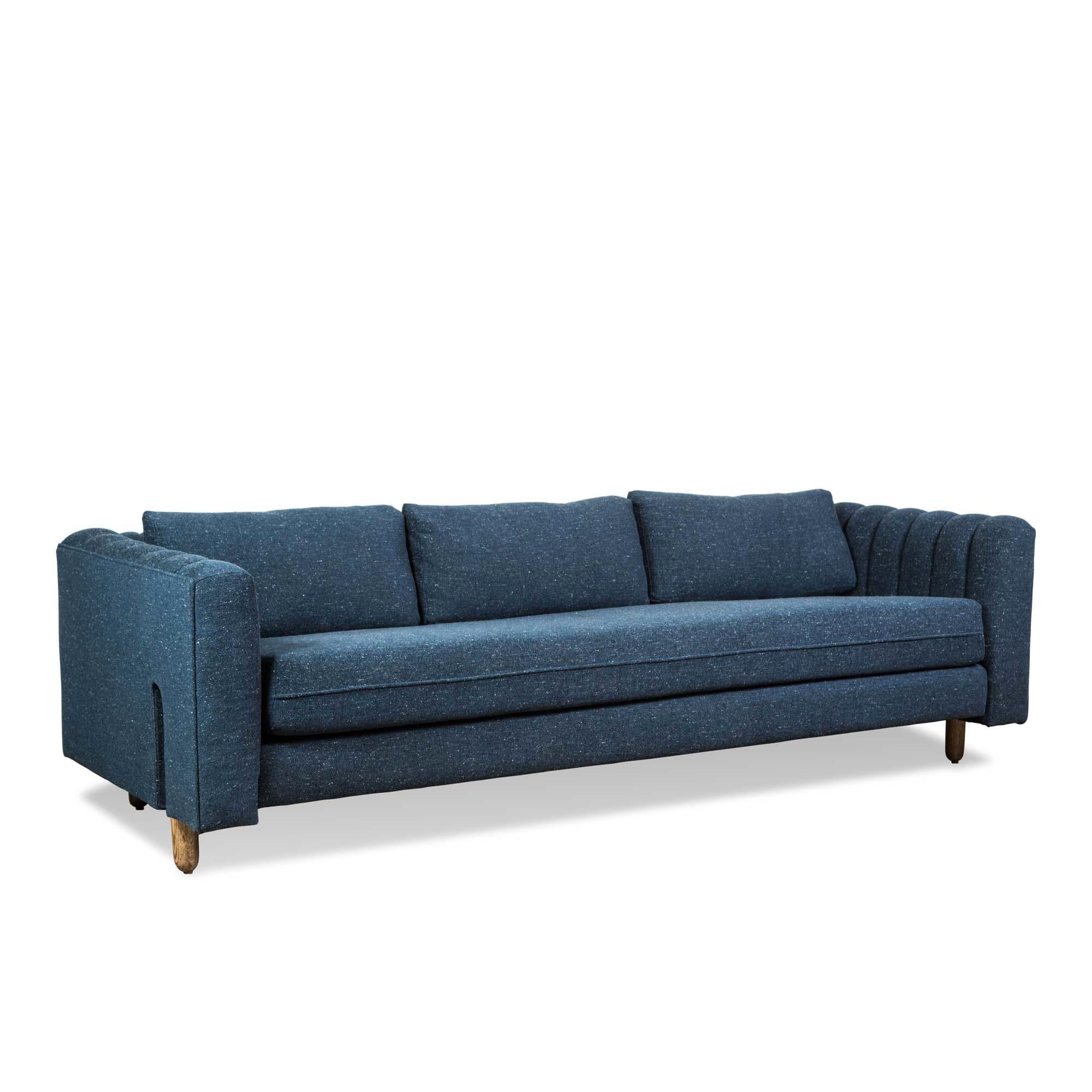 The Isherwood sofa features a channel tufted body with loose bolster cushions. The turned legs are made of solid white oak or American walnut and are inset on the sides revealing the leg detail. 

The Lawson-Fenning Collection is designed and