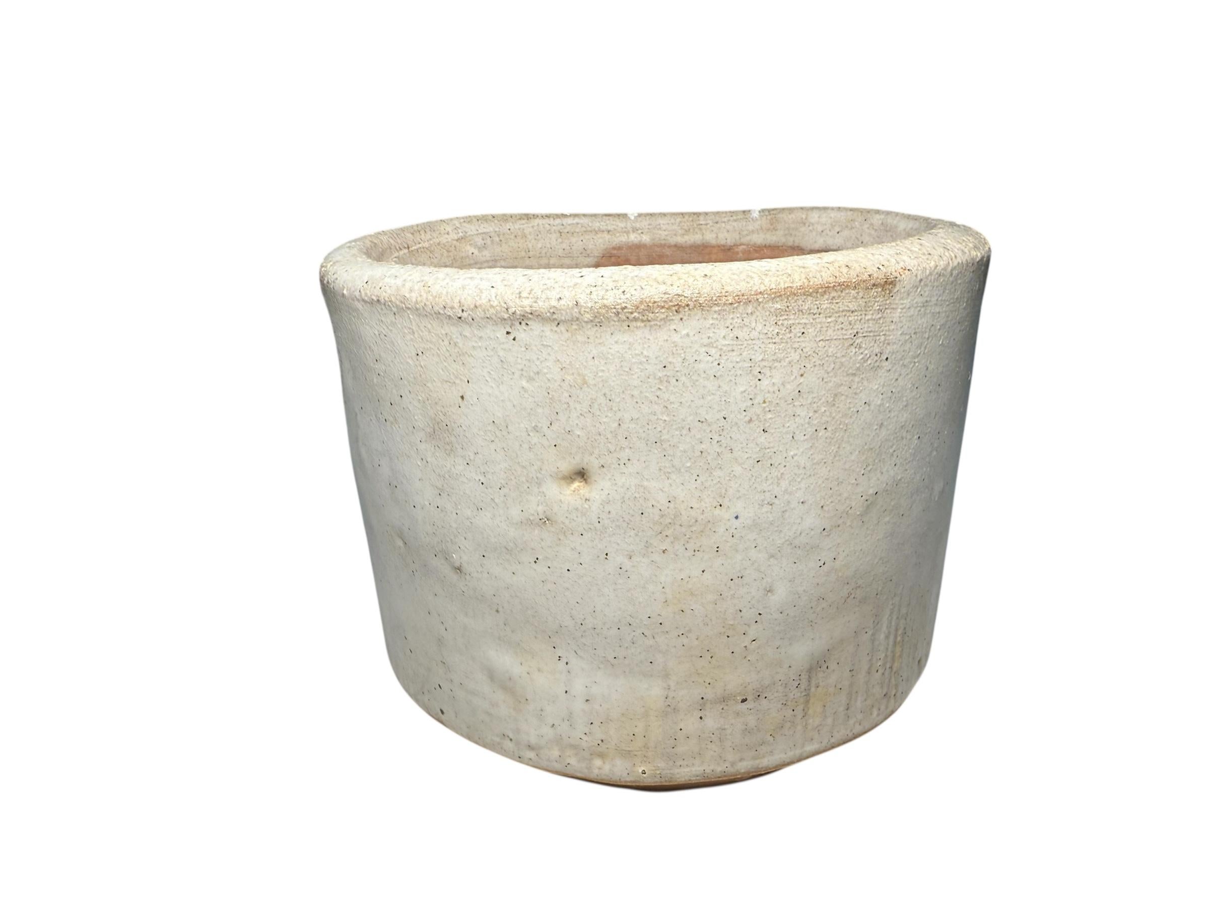 This is a Puerto Rican Stoneware Planter. It depicts a round small planter hand painted pearly white color. This Puerto Rican Pottery Workshop ( 1962 - 70’s ) is renowned by a group of talented pottery makers who created geometrical patterns designs