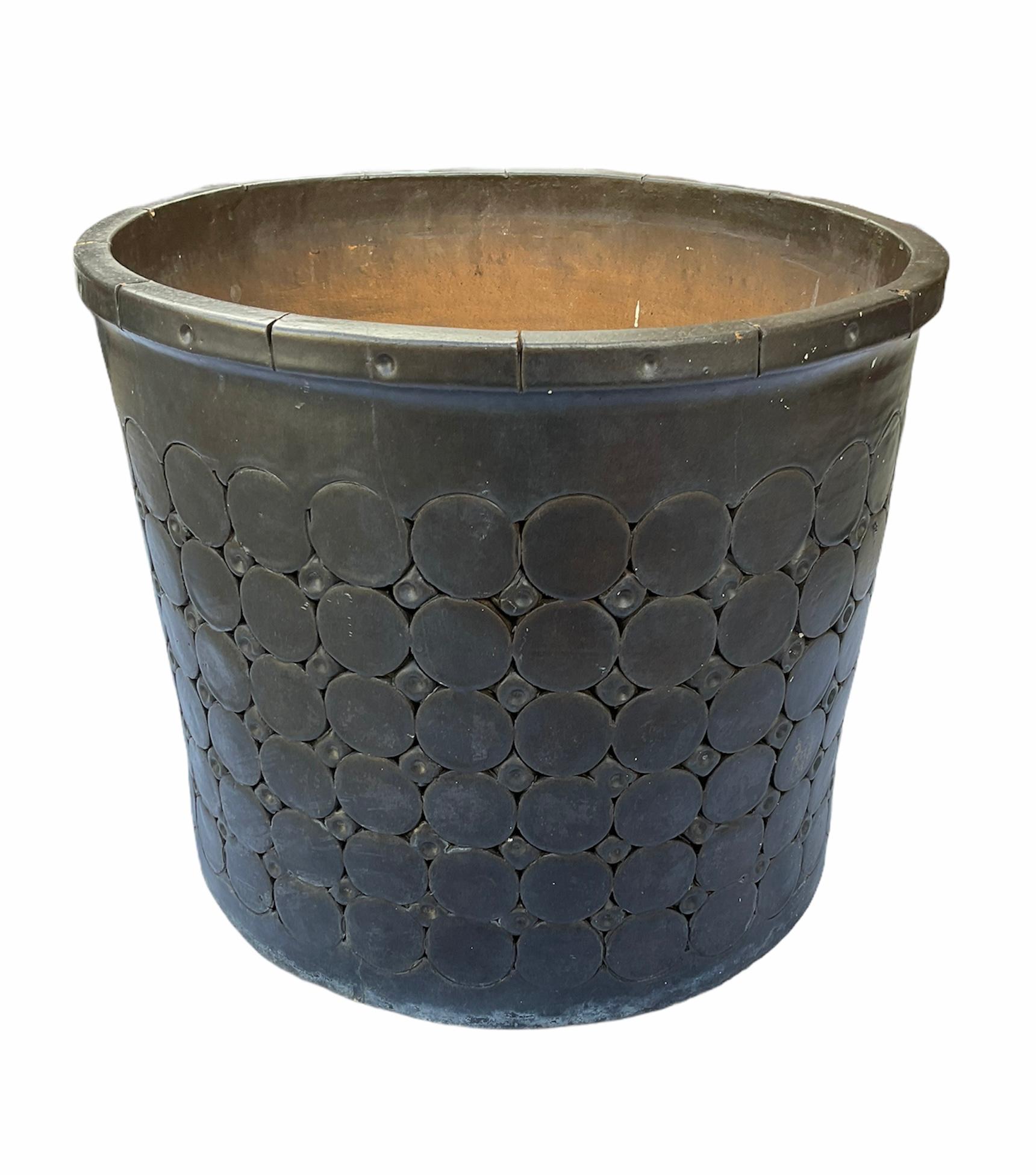 This is an Isla Del Sol Puertorican huge and heavy stoneware round planter. It is hand painted black and adorned with six rows of large circles alternated by five rows of small circles. This planter weights about 60 pounds.