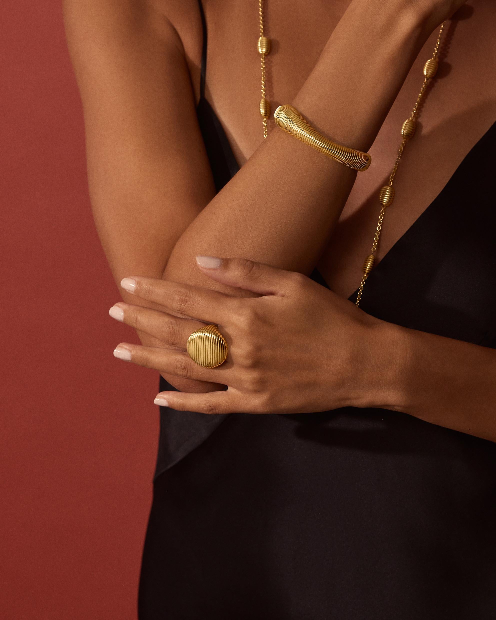 Isla brings form to Pamela’s love of working with texture and shape. A gleaming finish of polished ridges and sandblasted channels evokes both the nobility of ancient worlds and the glamour of the 70’s.

18K yellow gold, 23.64g
Finely crafted in