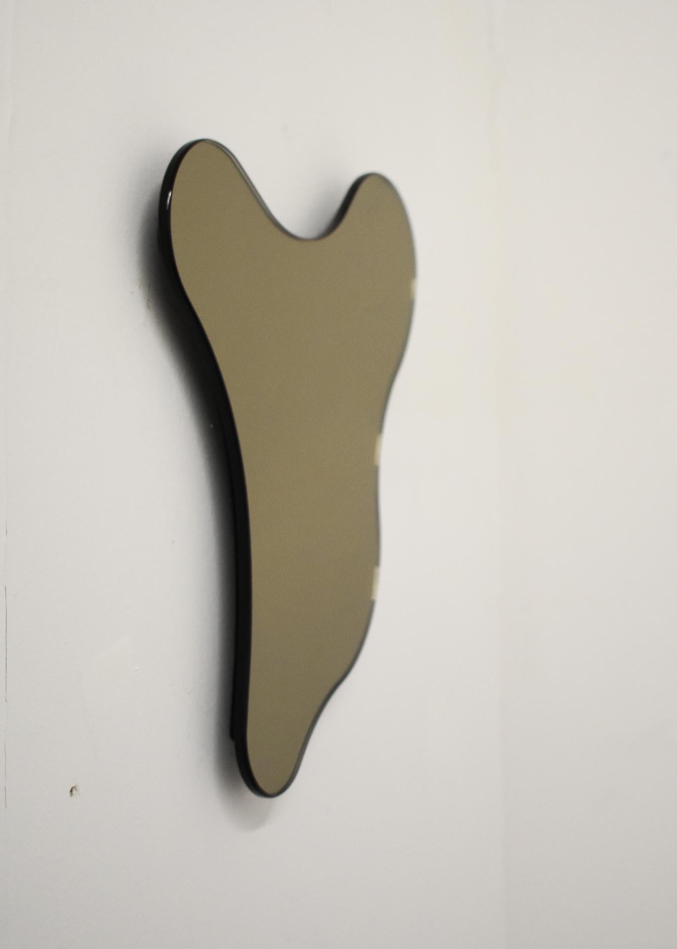 ISLA MIRROR - No. 1
Materials: Bronze Glass, Black MDF 
Dimensions: 10.25”W X 1”D X 11”H

Minimalist, elegant, amorphically shaped floating bronze glass mirrors inspired by the topography of the Philippine archipelago. The ISLA Mirrors are