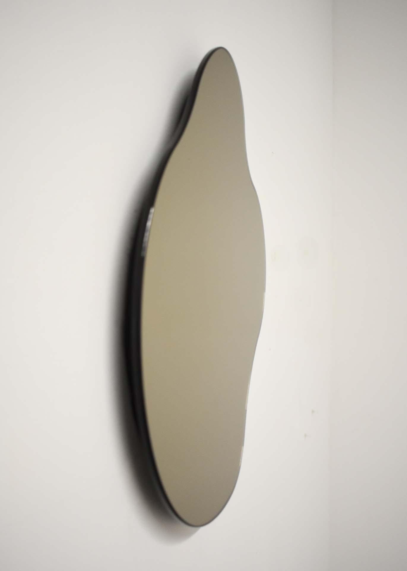 ISLA MIRROR - No. 3
Materials: Bronze Glass, Black MDF 
Dimensions: 13”W X 1”D X 15.25”H

Minimalist, elegant, amorphically shaped floating bronze glass mirrors inspired by the topography of the Philippine archipelago. The ISLA Mirrors are available