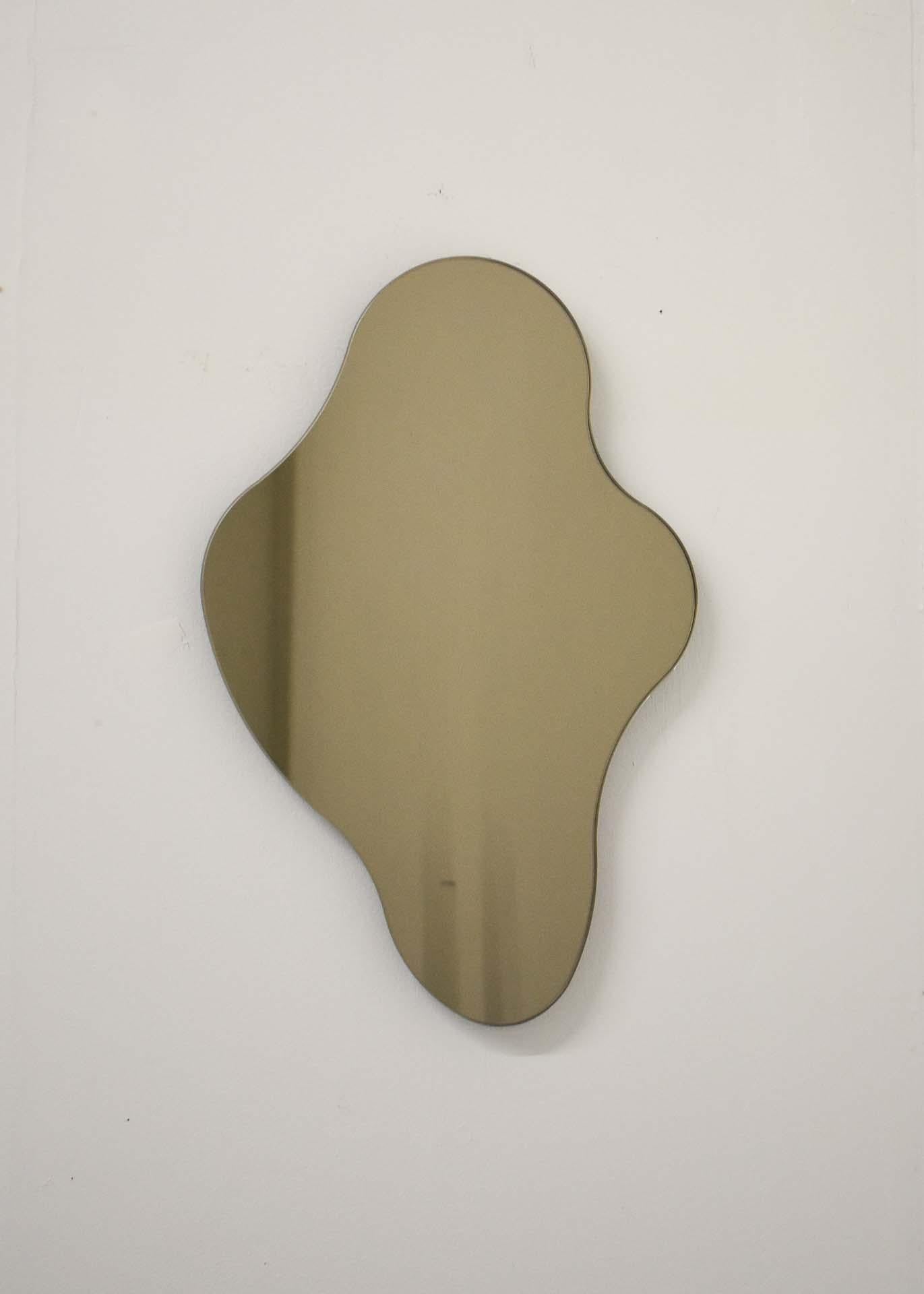 ISLA MIRROR - No. 1
Materials: Bronze Glass, Black MDF 
Dimensions: 10.75”W X 1”D X 16.75”H

Minimalist, elegant, amorphically shaped floating bronze glass mirrors inspired by the topography of the Philippine archipelago. The ISLA Mirrors are