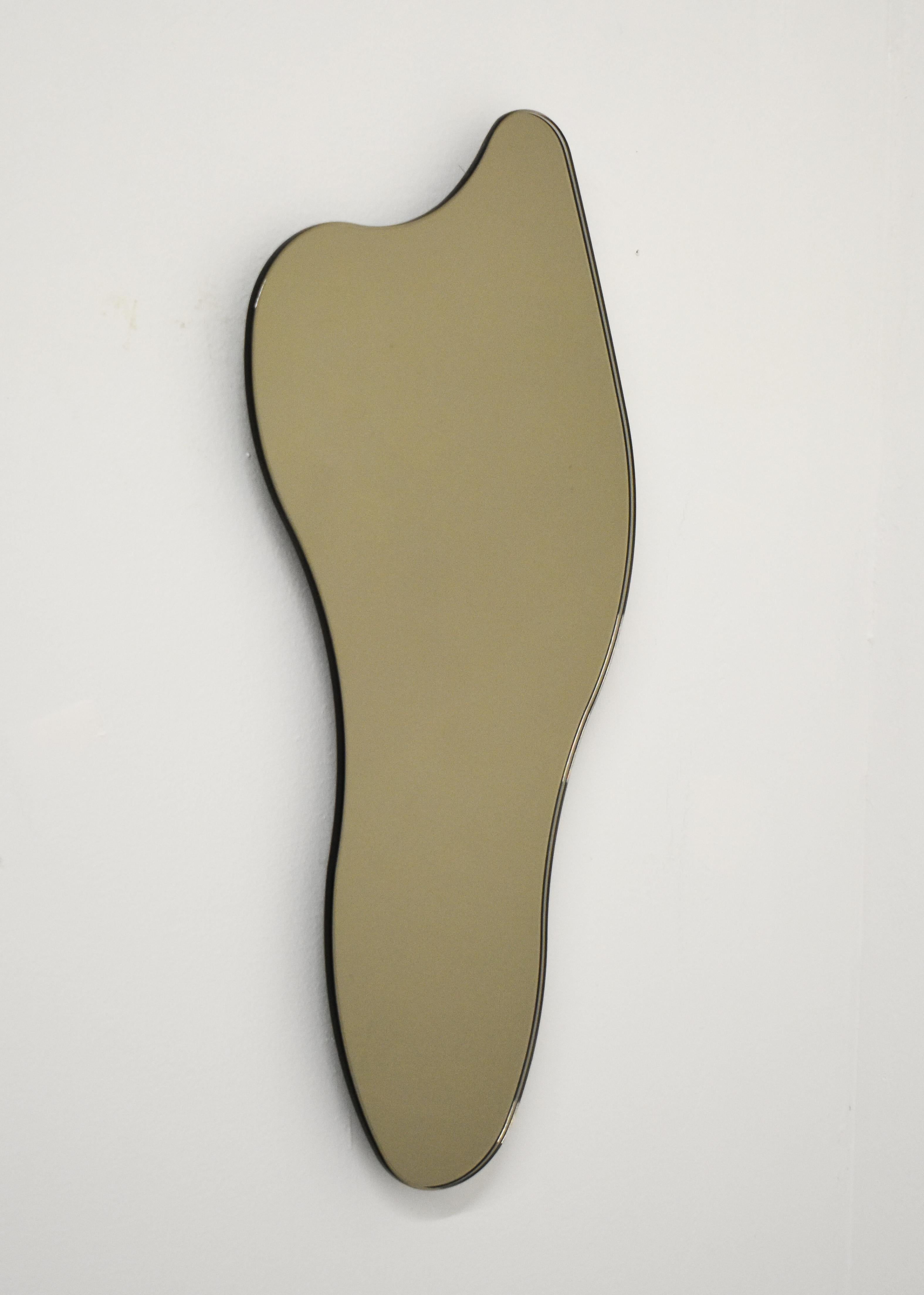 ISLA MIRROR - No. 5
Materials: Bronze Glass, Black MDF 
Dimensions: 8.25”W X 1”D X 17”H

Minimalist, elegant, amorphically shaped floating bronze glass mirrors inspired by the topography of the Philippine archipelago. The ISLA Mirrors are