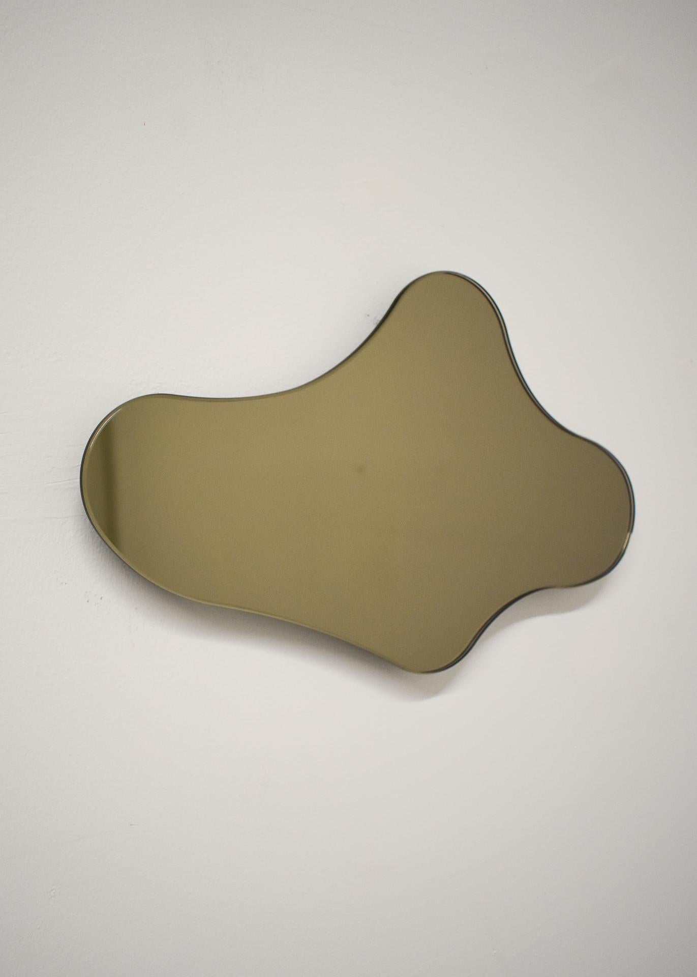 ISLA MIRROR - No. 6
Materials: Bronze Glass, Black MDF 
Dimensions: 13.25”W X 1”D X 8.75”H

Minimalist, elegant, amorphically shaped floating bronze glass mirrors inspired by the topography of the Philippine archipelago. The ISLA Mirrors are