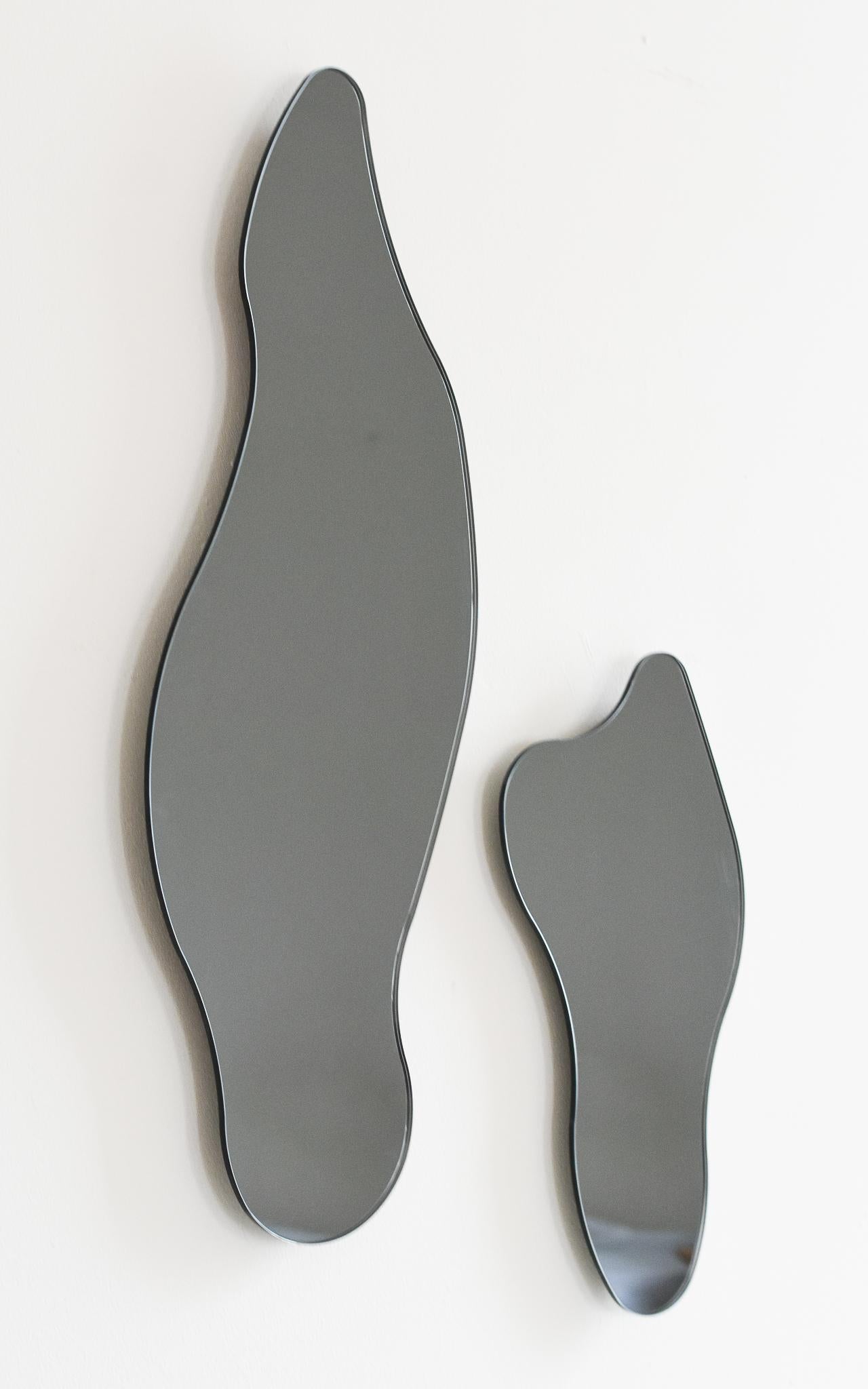 ISLA MIRRORS - Composition No. 2
Materials: Smoke Grey Glass, Black MDF
Dimensions: 20”W X 1”D X 28”H

Minimalist, elegant, amorphically shaped floating glass mirrors inspired by the topography of the Philippine archipelago. The ISLA Mirrors are