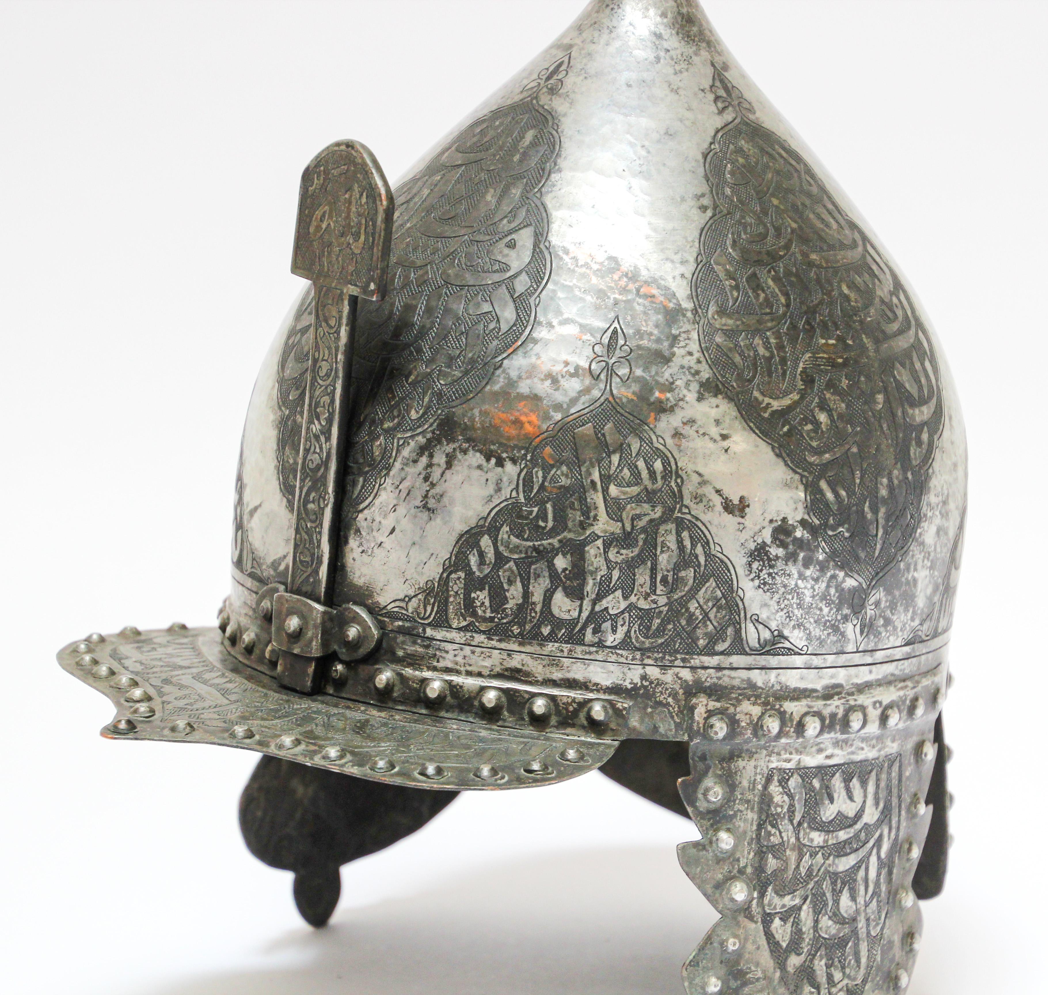 Islamic Indo Persian kulah khud helmet with Arabic hand engravings.
Hand forged, made of heavy tinned copper metal Middle eastern influence warrior helmet decorated with hand chisel Arabic calligraphy writing.
Indo Persian Islamic steel helmet of