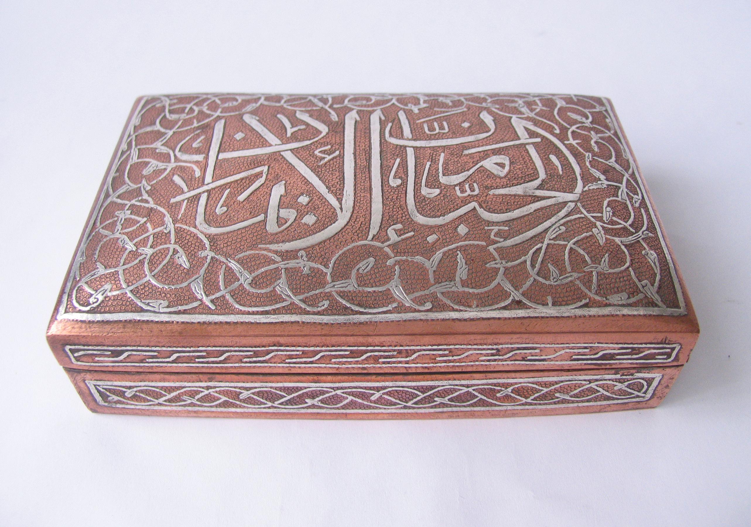 Islamic silver calligraphy inlay damascened copper jewelry box with hinged lid and wood interior.
Hand hammered copper and silver Inlay work done by craftsman in the old Cairo market, Egypt.
This is also called the Mamluk revival style, or Cairoware.