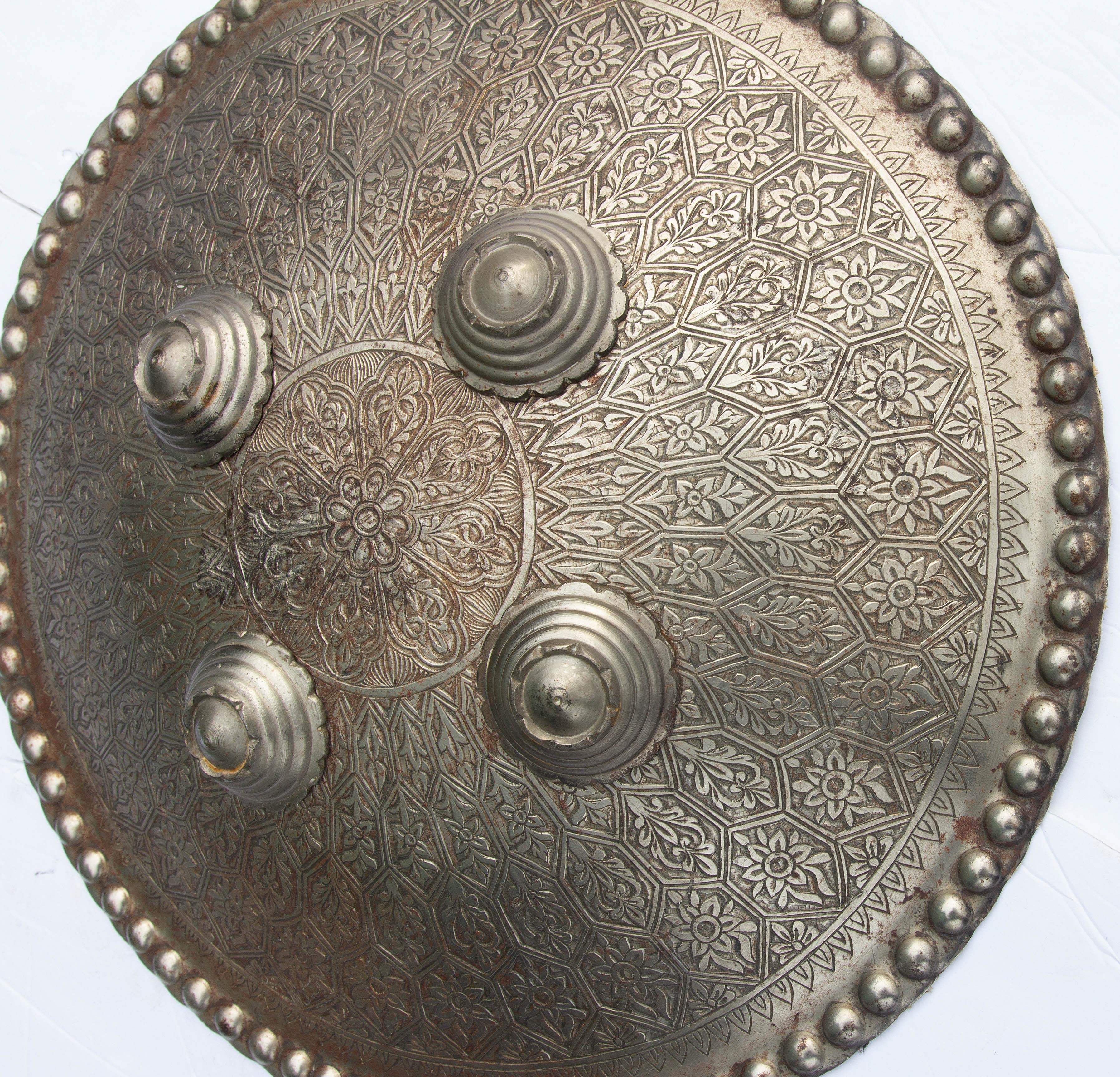 Persian and iron shield. Engraved with Moresque designs . Woven  interior. Early 20th century.