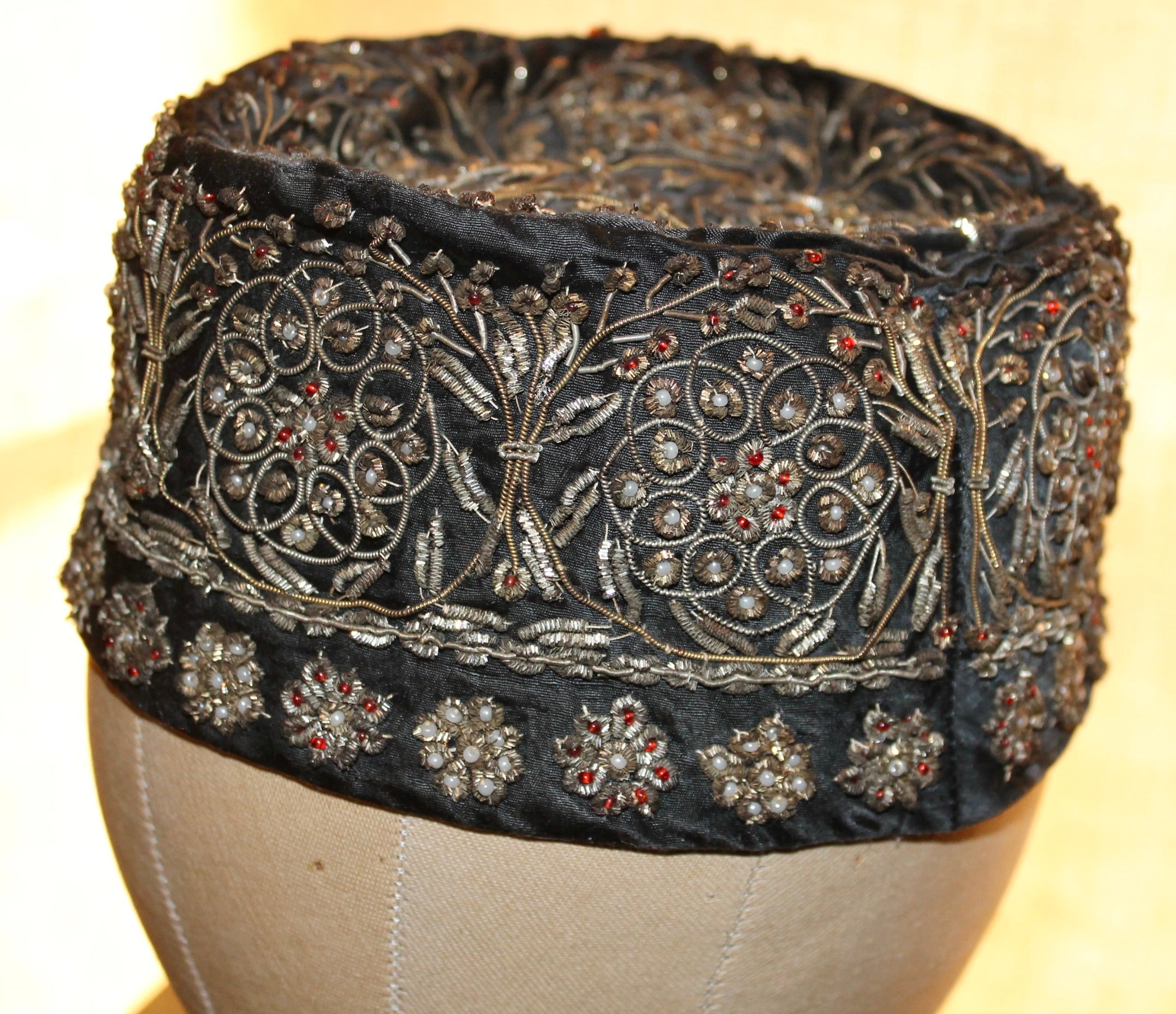 Tribal embroidered with metallic threads, and  faux gem glass beads. These hats though mostly 19c. , were repurposed in the 60's as woman's 'Pill Box' hats. Approximately 21