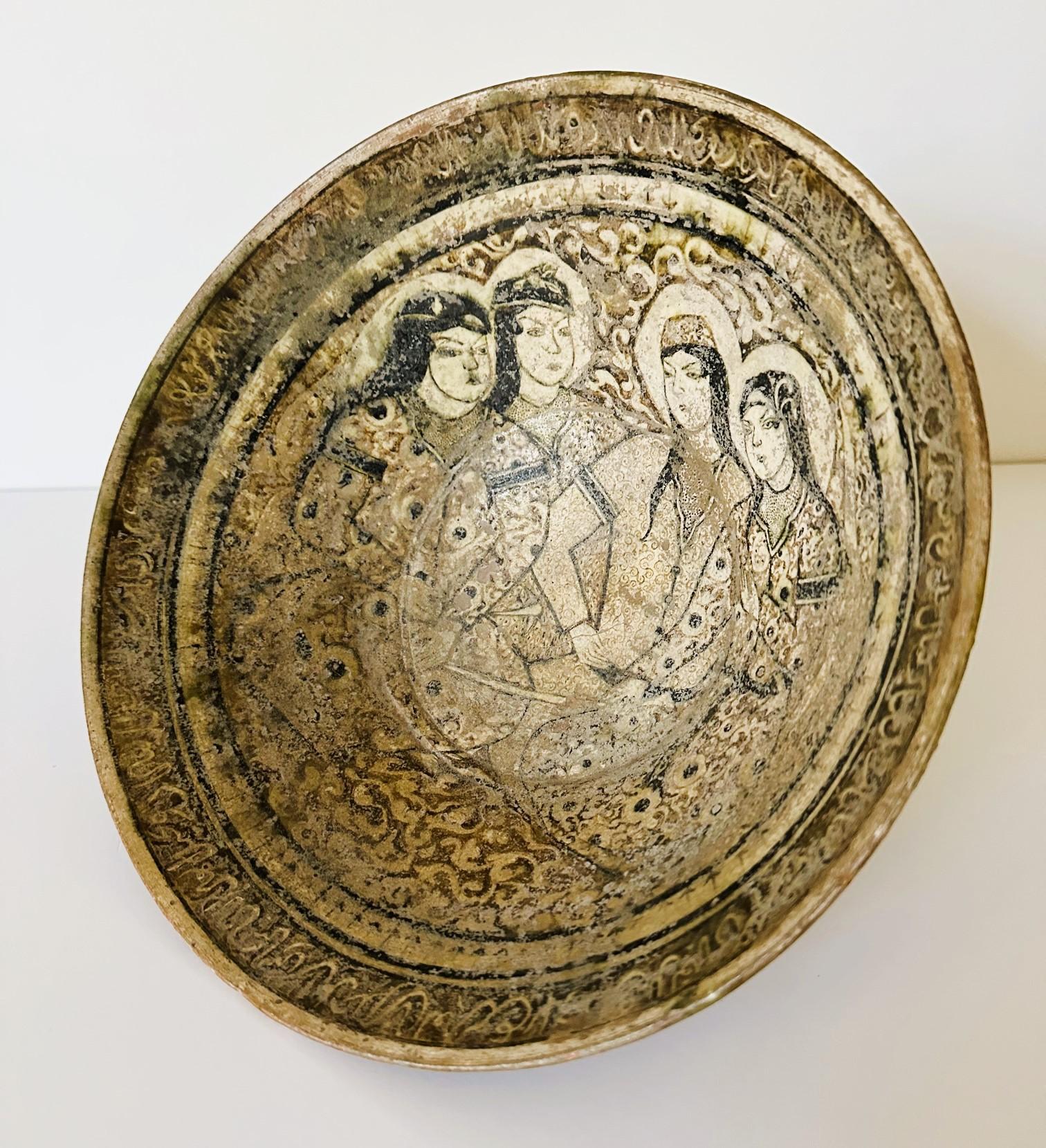 An earthenware bowl supported on a foot ring decorated with elaborate slip paint. The bowl was made in Kashan (in nowadays Iran) during 12-14th century, under Seljuk empire or after Mongols invasion. The likely frit ware bowl features a thinly