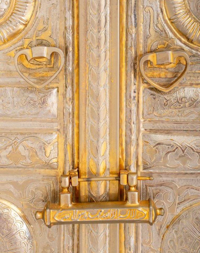 SIlvered metal representation of the Kaaba door in Mecca, Saudi Arabia, with sayings from the Qur'an in the rectangular raised panels, framed.  Provenance: Removed from a 157 East 57th Street estate.