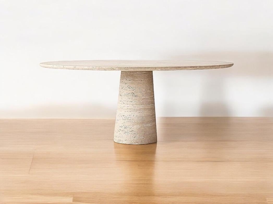 'Island' Round Dining Table in Beige Travertine Stone
Island dining table showcases the refined simplicity and subtle elegance characteristic of Italian minimalist style. Constructed from natural stone travertine, the table's gently narrowing