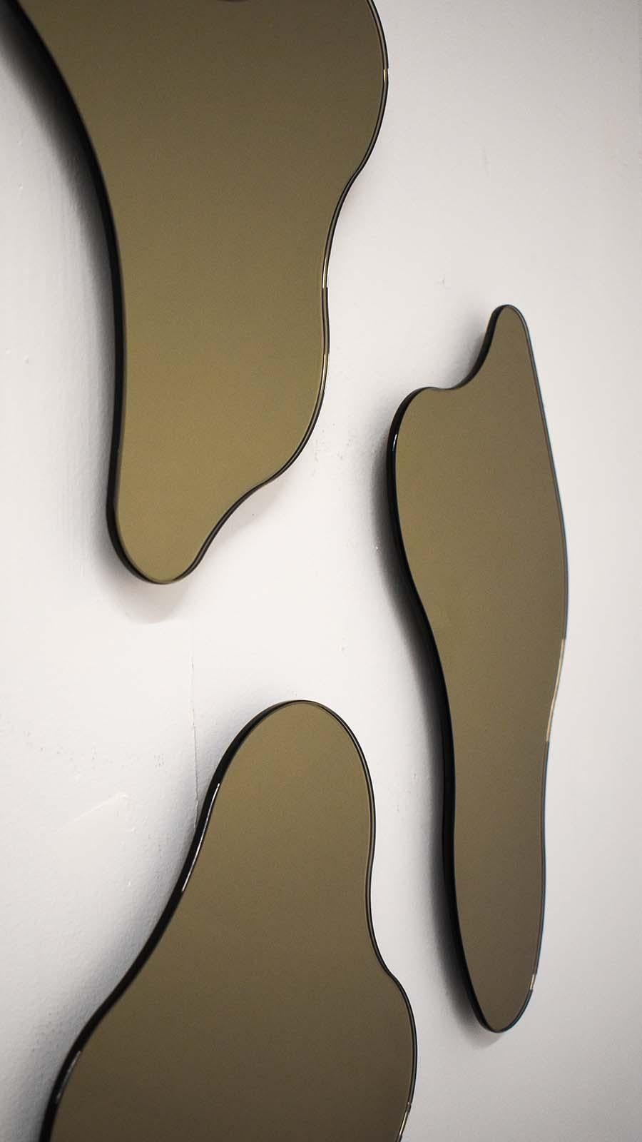 ISLA MIRRORS - Composition No. 3
Materials: Bronze Glass, Black MDF 
Dimensions: 19”W X 1”D X 29”H

Minimalist, elegant, amorphically shaped floating bronze glass mirrors inspired by the topography of the Philippine archipelago. The ISLA Mirrors