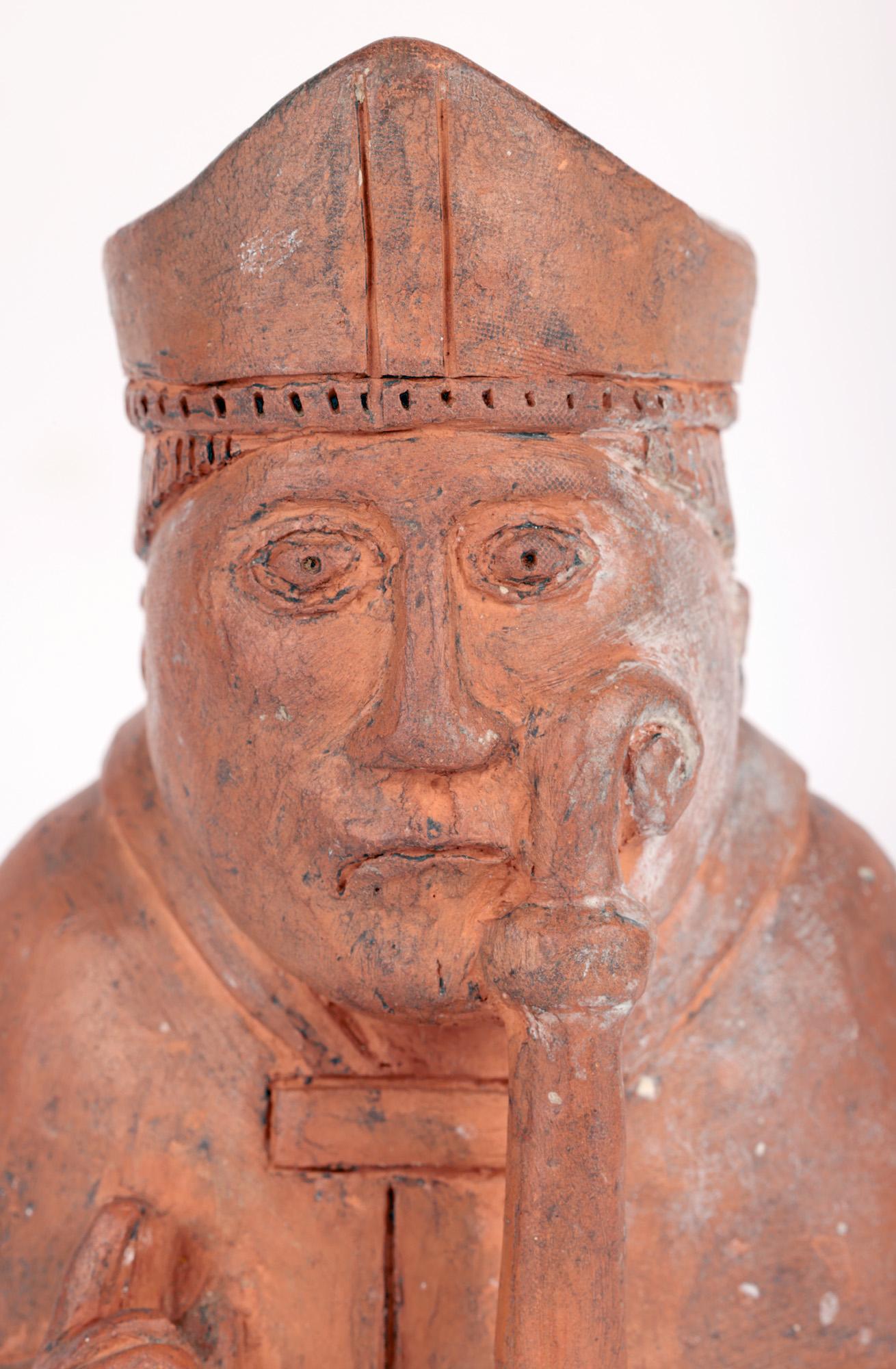 A very unusual Scottish terracotta figure of a Bishop chess piece based on a hoard found on the Isle of Lewis in 1831 and believed to date to the latter 19th or early 20th century. The chess piece portrays a seated bishop dressed in robes and mitre