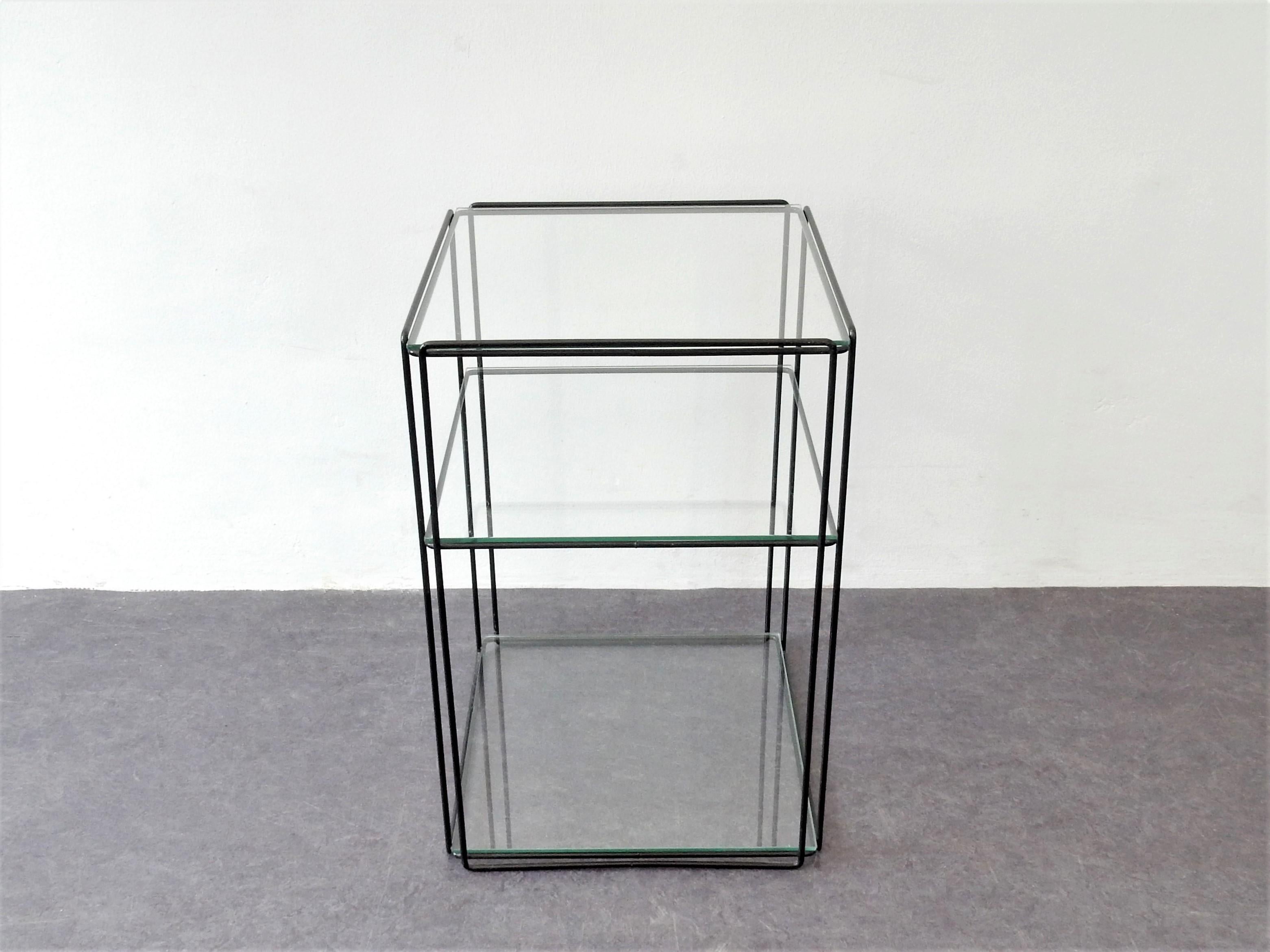 This graphical side table, model 'Isocele', was designed by Max Sauze in France in the 1970s. It has a black metal frame with 3 glass plates. A beautiful design that gives an airy effect to your room. This table is in a very good condition with very