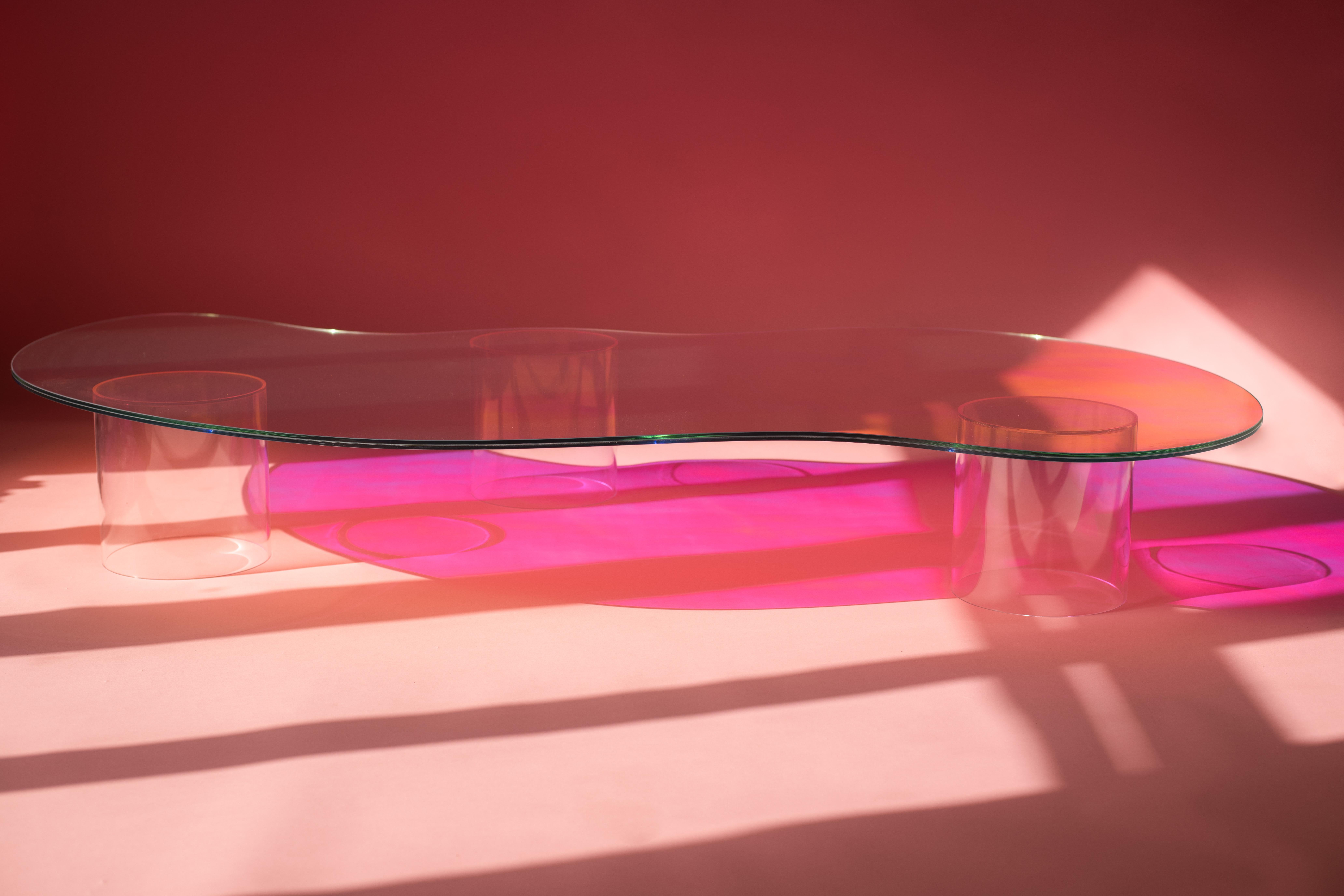 Isola coffee table by Brajak Vitberg.
Dimensions: D 195 x W 100 x H 27 cm.
Materials: laminated dichroic glass + plexi glass.

The table is made out of glass with satin finish and dichroic insert.
The colors in this kind of satin finish are