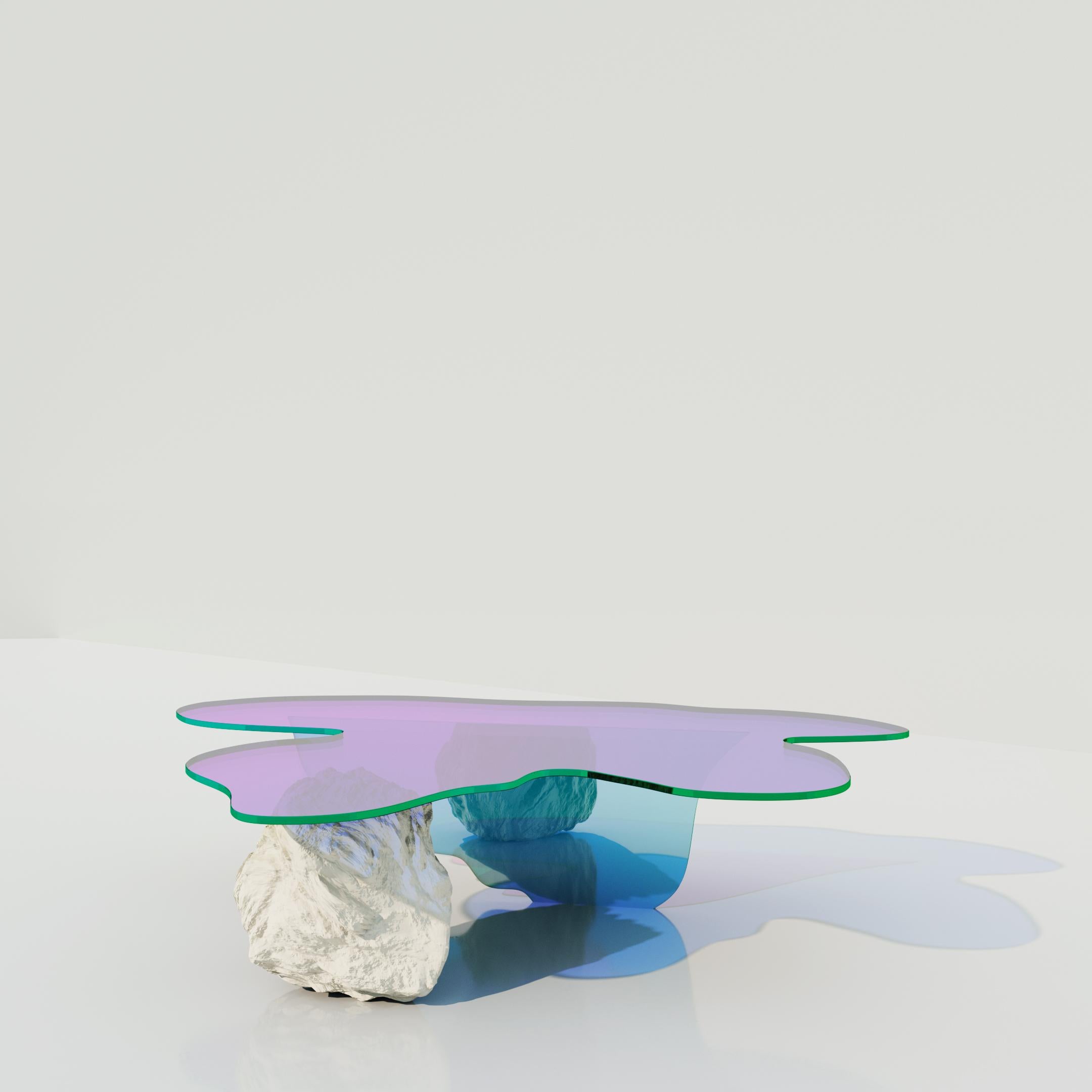 Isola coffee table by Brajak Vitberg
Dimensions: 30 x 100 x 120 cm
Materials: Dichroic glass, natural stone

The table is made out of glass with satin finish and dichroic insert.
The colors in this kind of satin finish are more subtle but still