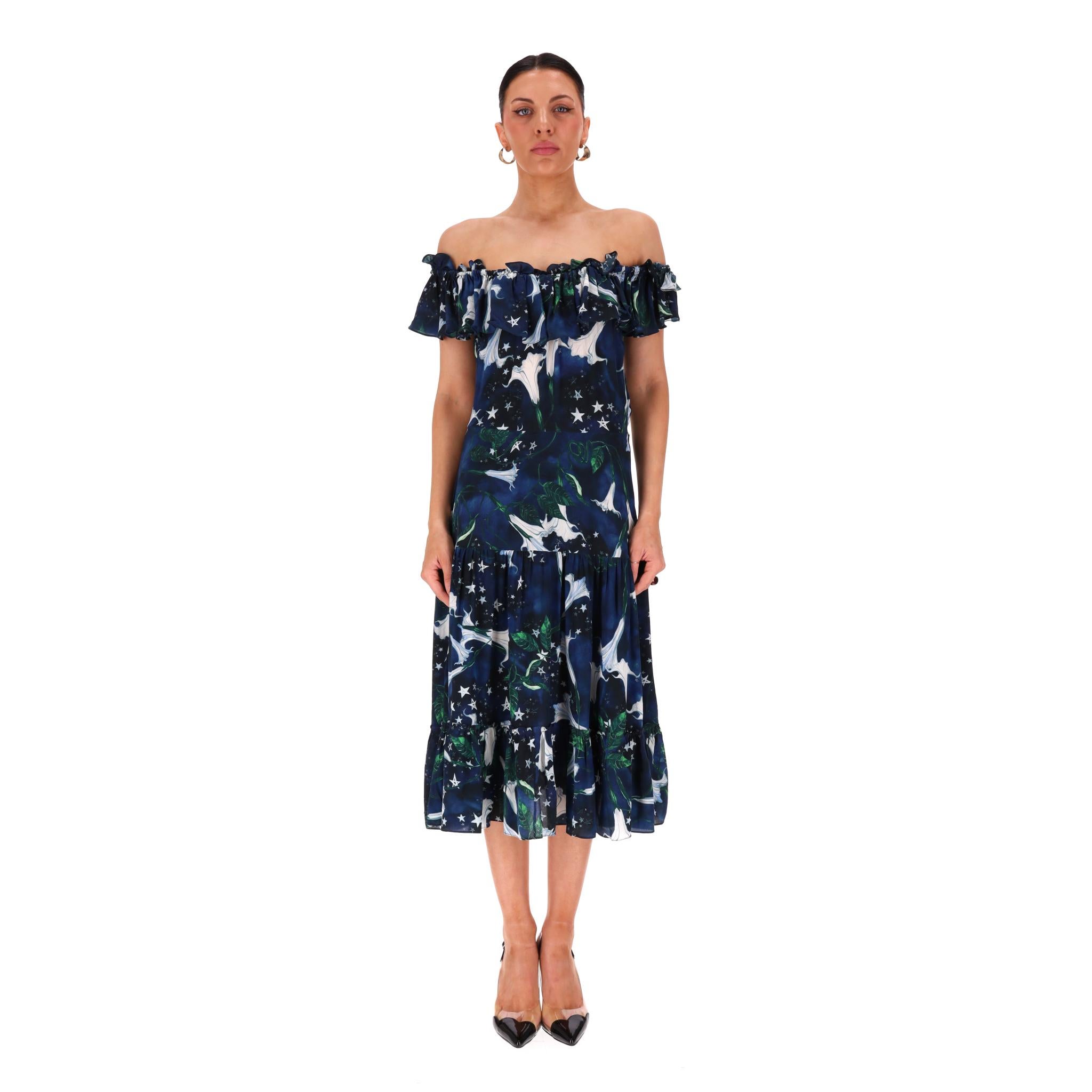 Isolda - Vestito in seta con volant e spalle scoperte

Abito navy interamente realizzato in seta e disegnato con un motivo di gigli, foglie e stelle bianche all-over.

Caratterizzato da spalle scoperte con dettagli arruffati e gonna midi