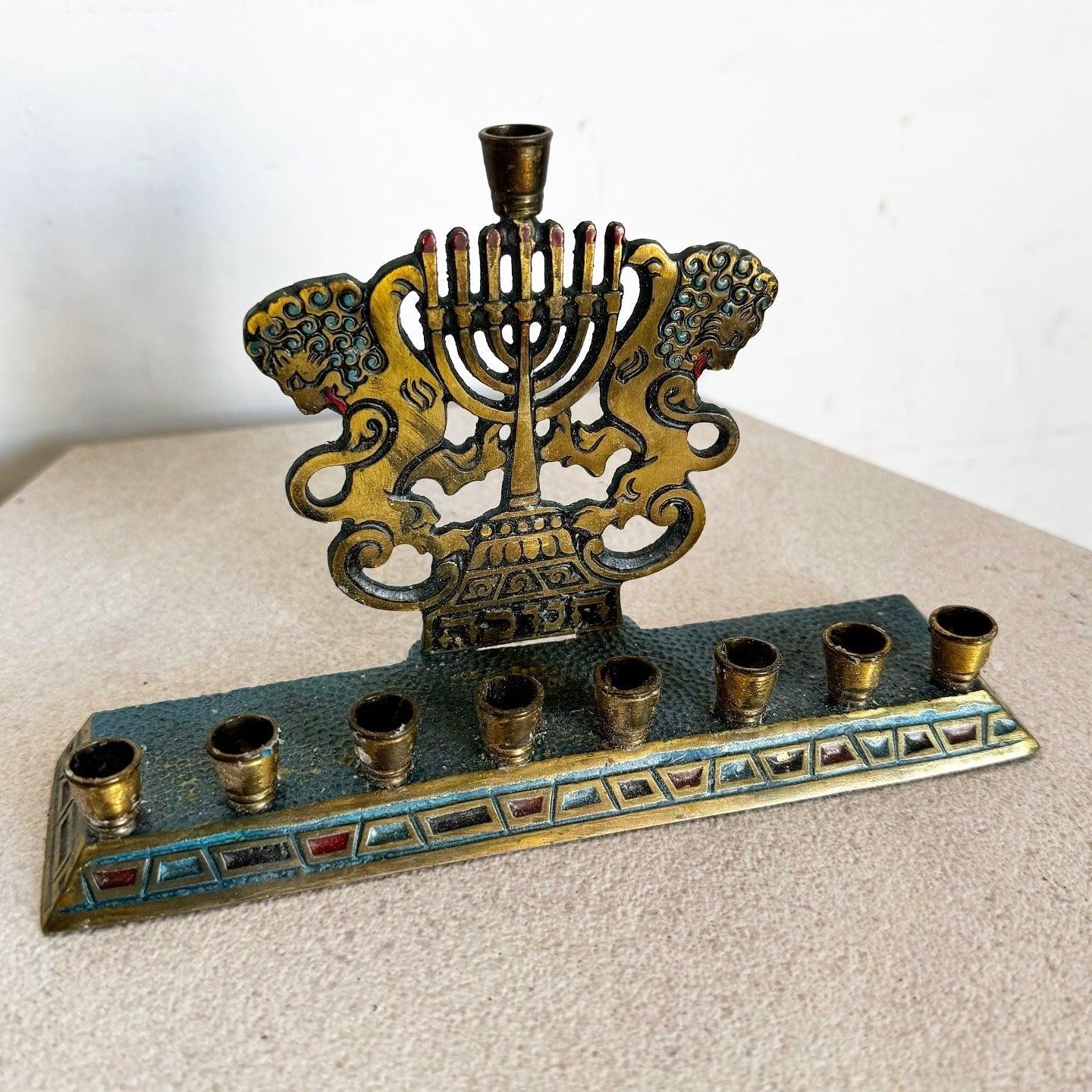Israeli Brass Lions of Judah Menorah with hand-painted accents and hammered texture. Perfect for Hanukkah or as a stunning decorative piece.
 
 We sell items as acquired, without restoring or repairing. Vintage pieces may have age-related wear.
