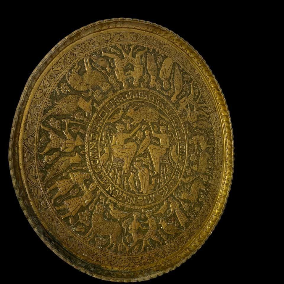 Israeli circular brass plate, 19th century, inscribed in Hebrew. An incredible monument for decorative brassware hanging of wall plates. It is embossed with a couple seated in a garden surrounded by wildlife and fauna, in wonderful vintage condition