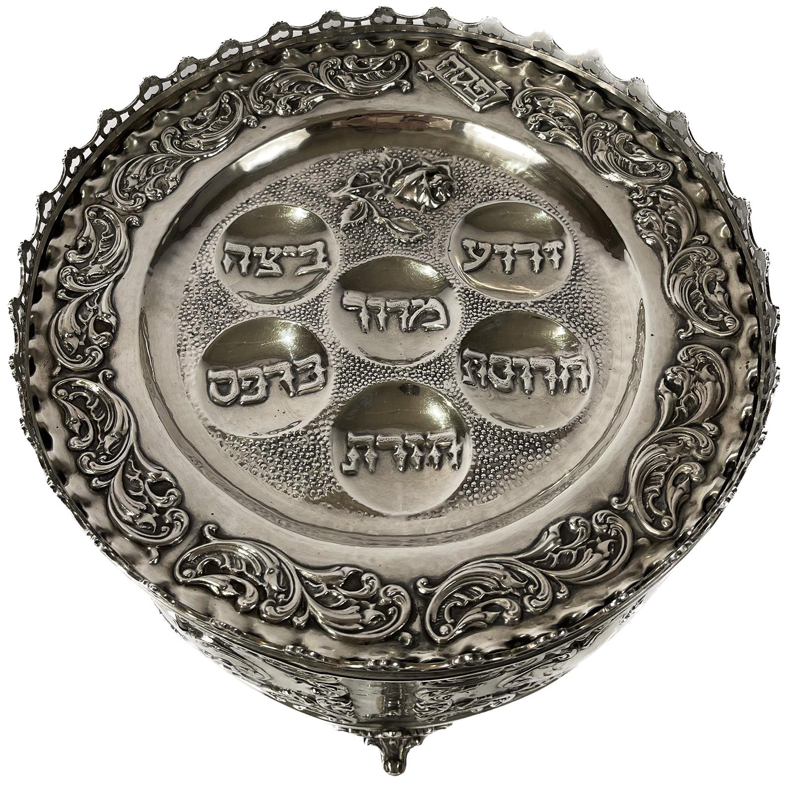 An Israeli sterling footed three-tier Seder Kaarah in a repousse style. This Sedar Kaarah features a sterling removable seder plate with six concave circles each with Hebrew script representing the symbols of Pesach, set of hinged doors with latch,