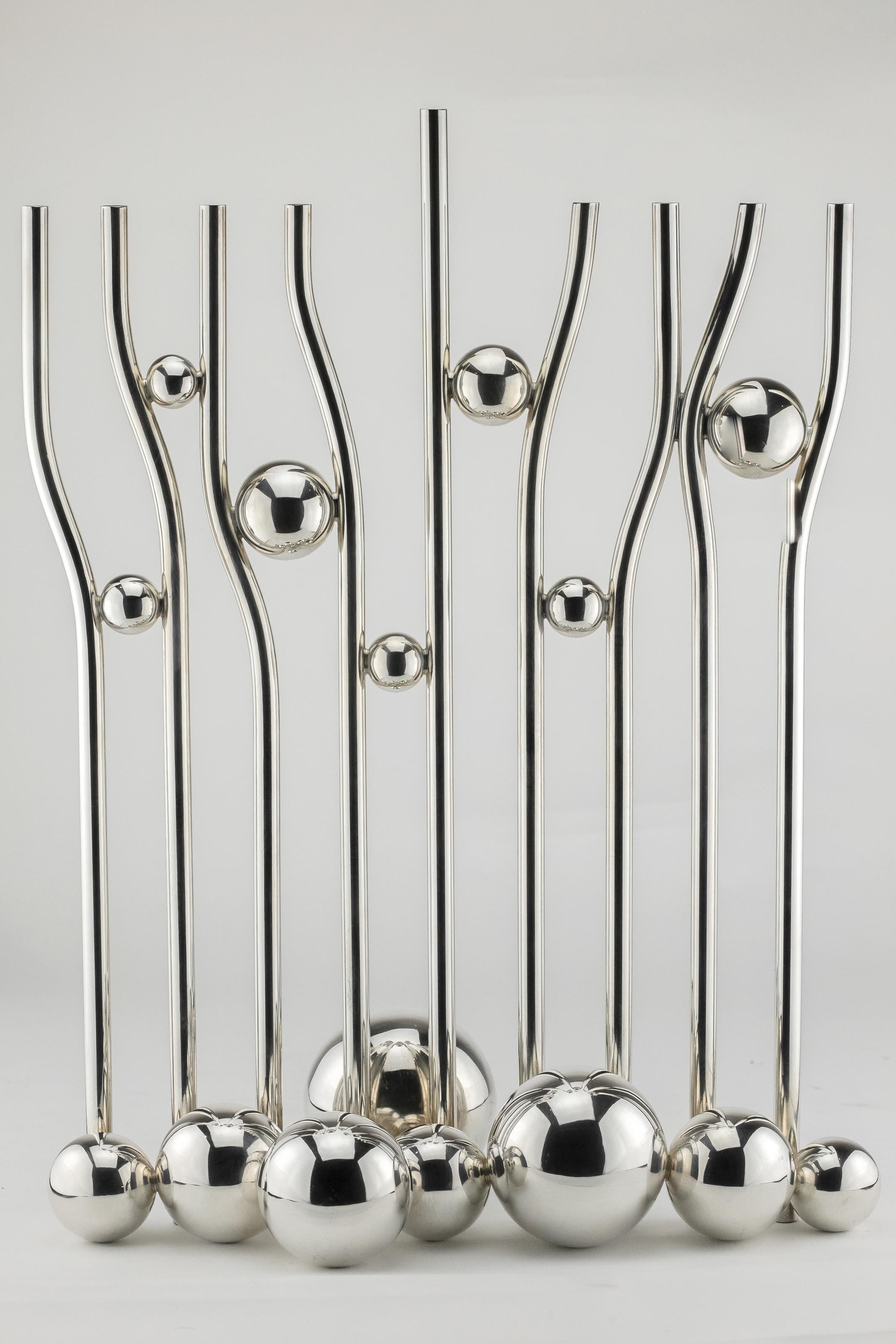 Sterling silver Hanukkah Lamp, Arie Ofir, Jerusalem, Israel, circa 1980
Designed in Modern Style. Nine silver tubes divided by seven silver balls and support by eight silver balls at the base. 
Hallmarked in Hebrew and English; Arie Ofir, Jerusalem,