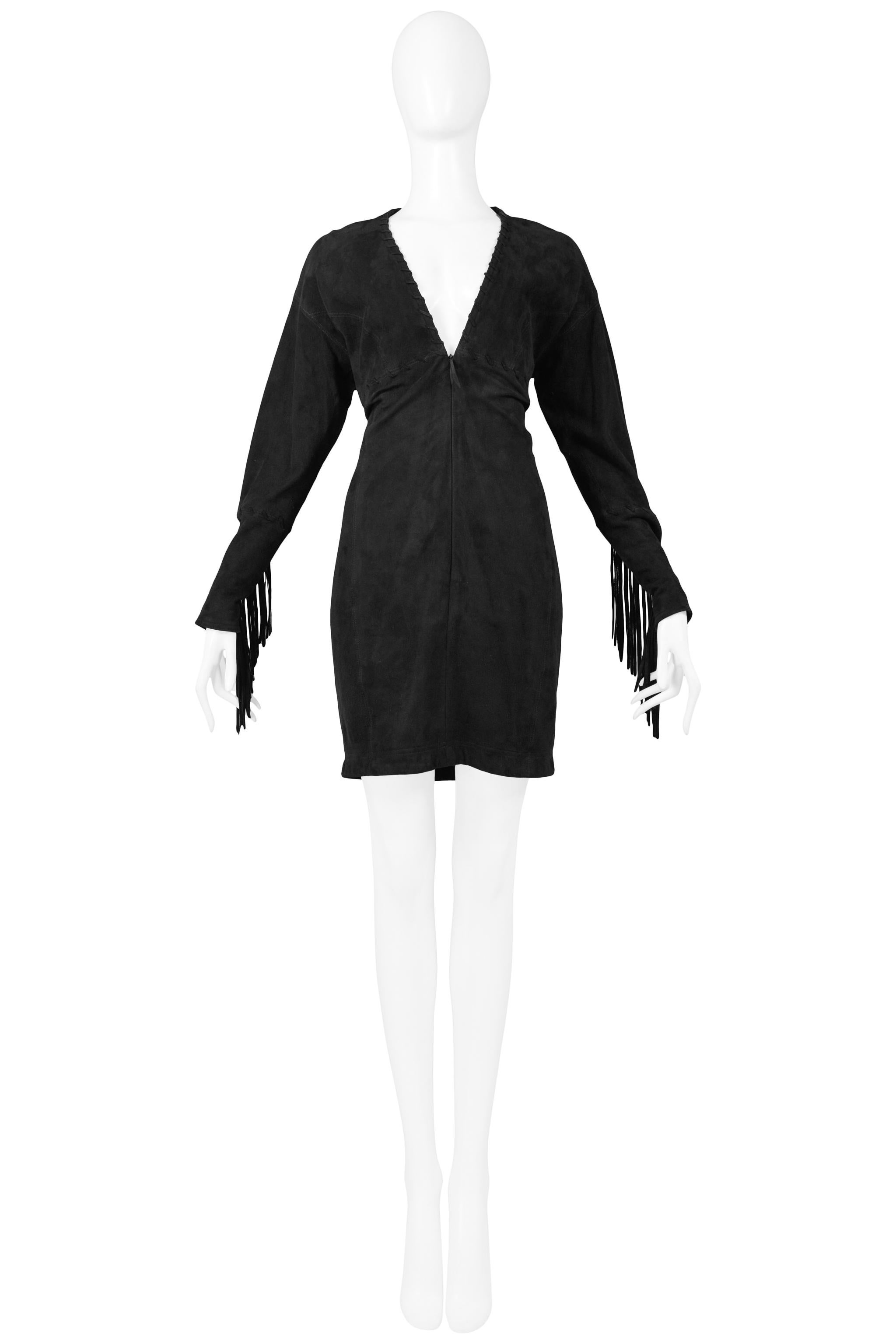 Resurrection is excited to offer this vintage Isaac Mizrahi black suede long sleeve mini dress featuring a deep v neckline, whipstitching, and a front zipper enclosure. Fringe detail along the bottom of the sleeve. 100% leather/lamb suede. 1989